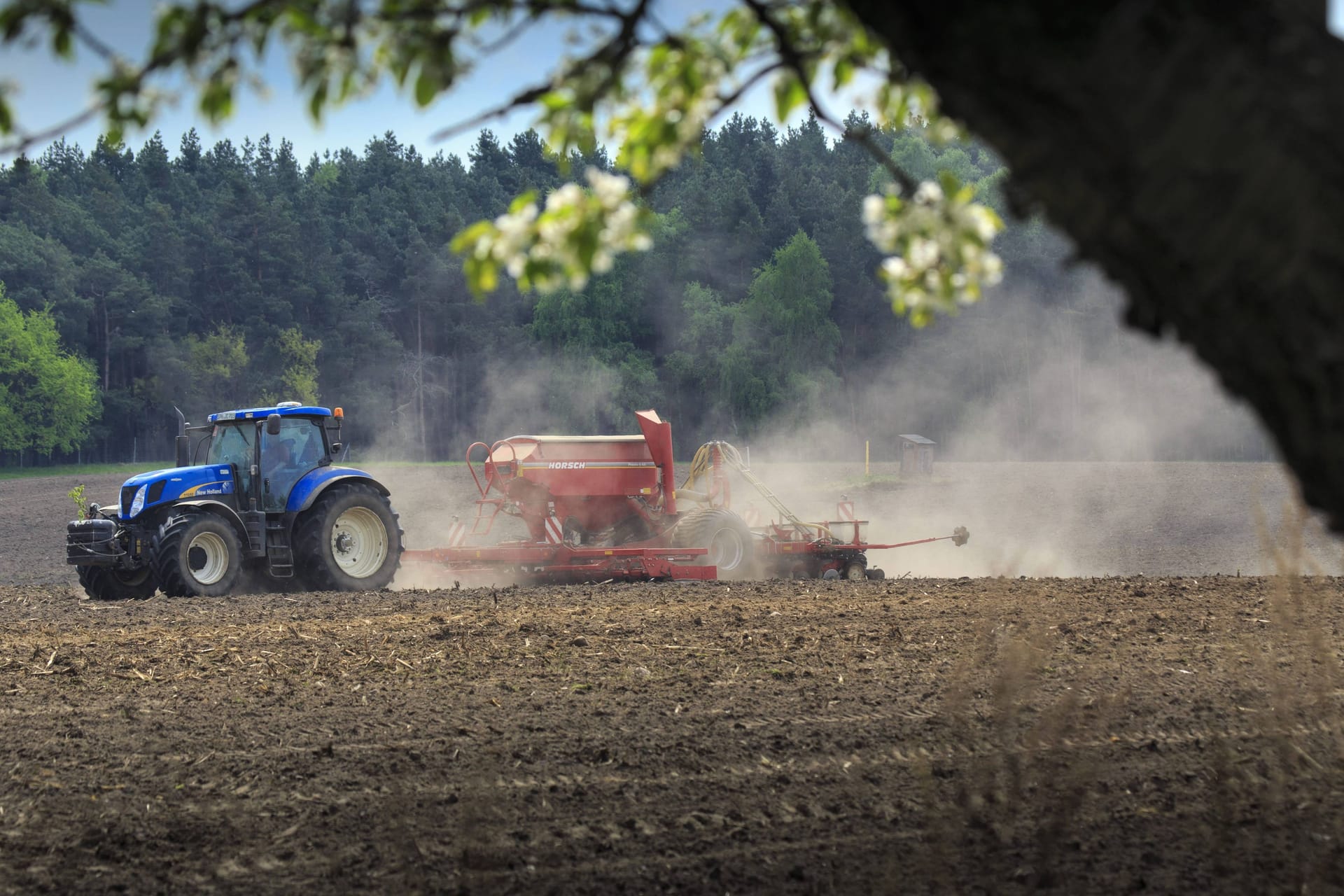 Ein Traktor fährt über einen Acker (Symbolbild): Um etwa einen Quadratmeter Ackerfläche zu schützen, wird in Nörvenich viel Aufwand betrieben.