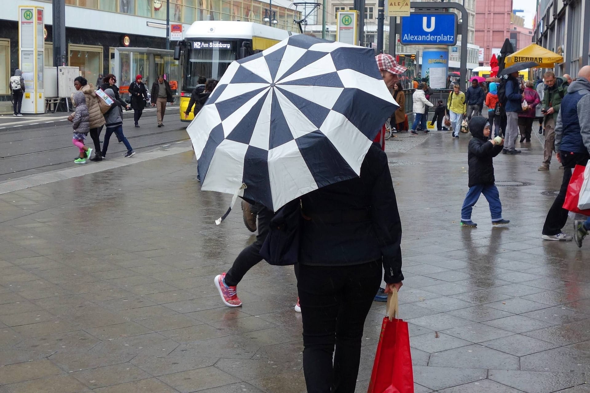 Menschen laufen durch den Regen in Berlin (Archivbild): Die neue Woche startet dank eines Tiefs mit ungemütlichem Wetter.