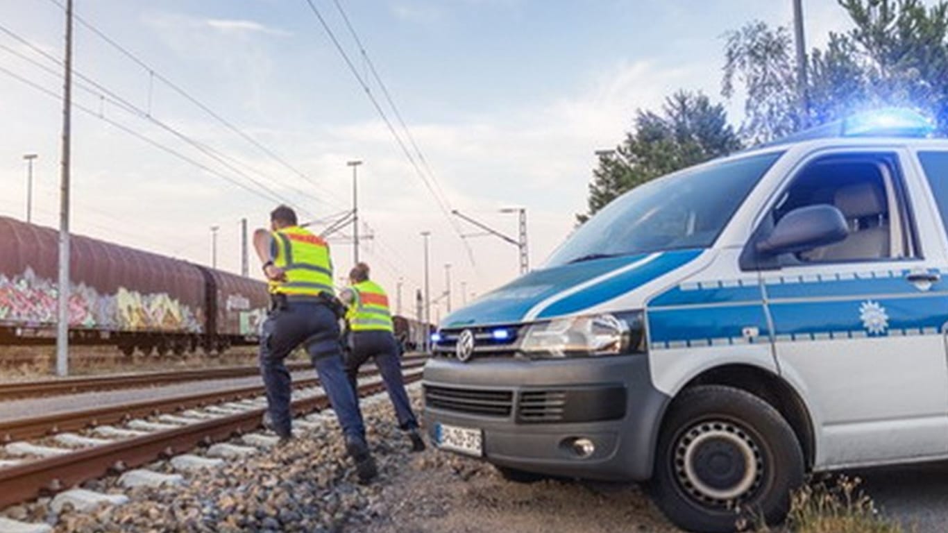 Polizisten halten Ausschau im Gleisbereich (Symbolbild). In Pasing/Obermenzing mussten Beamte zwei Kinder in Sicherheit bringen.