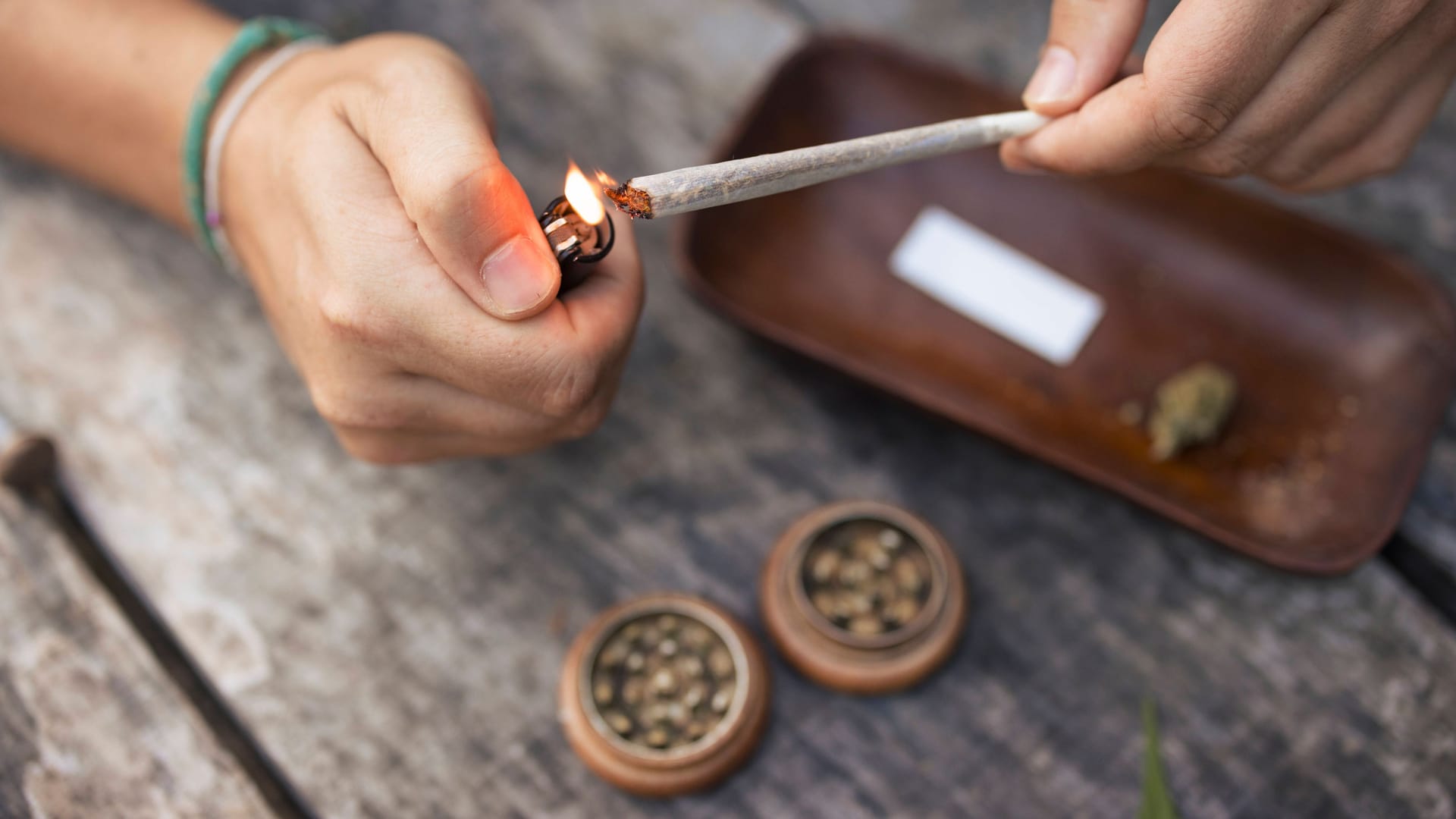 Eine Person zündet einen Joint an (Symbolbild): Wer in Niedersachsen gegen das Cannabisgesetz verstößt, soll hohe Straßen bezahlen müssen.