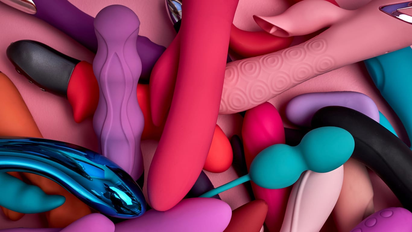 Bright stack of rubber sex toys flat lay