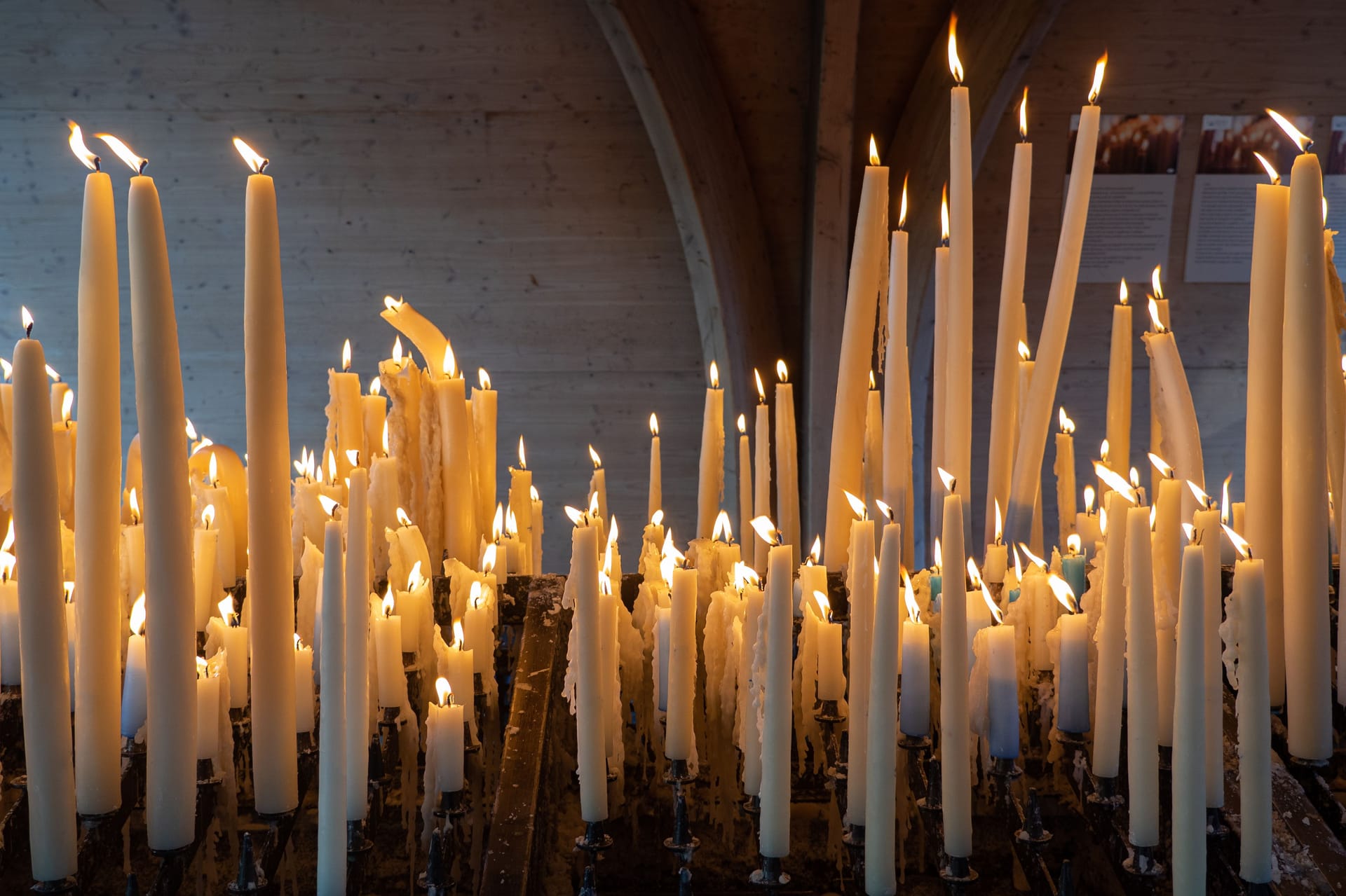 Burning candles lighted for belief or hope in Lourdes, France - Religion concept