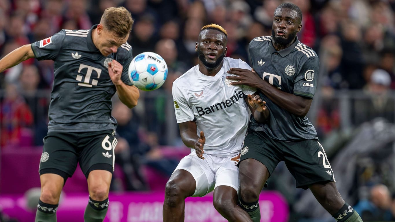 Leverkusens Victor Boniface (M.) im Duell mit Bayerns Joshua Kimmich (l.) und Dayot Upamecano: Das Pokalspiel wird in der ARD übertragen.