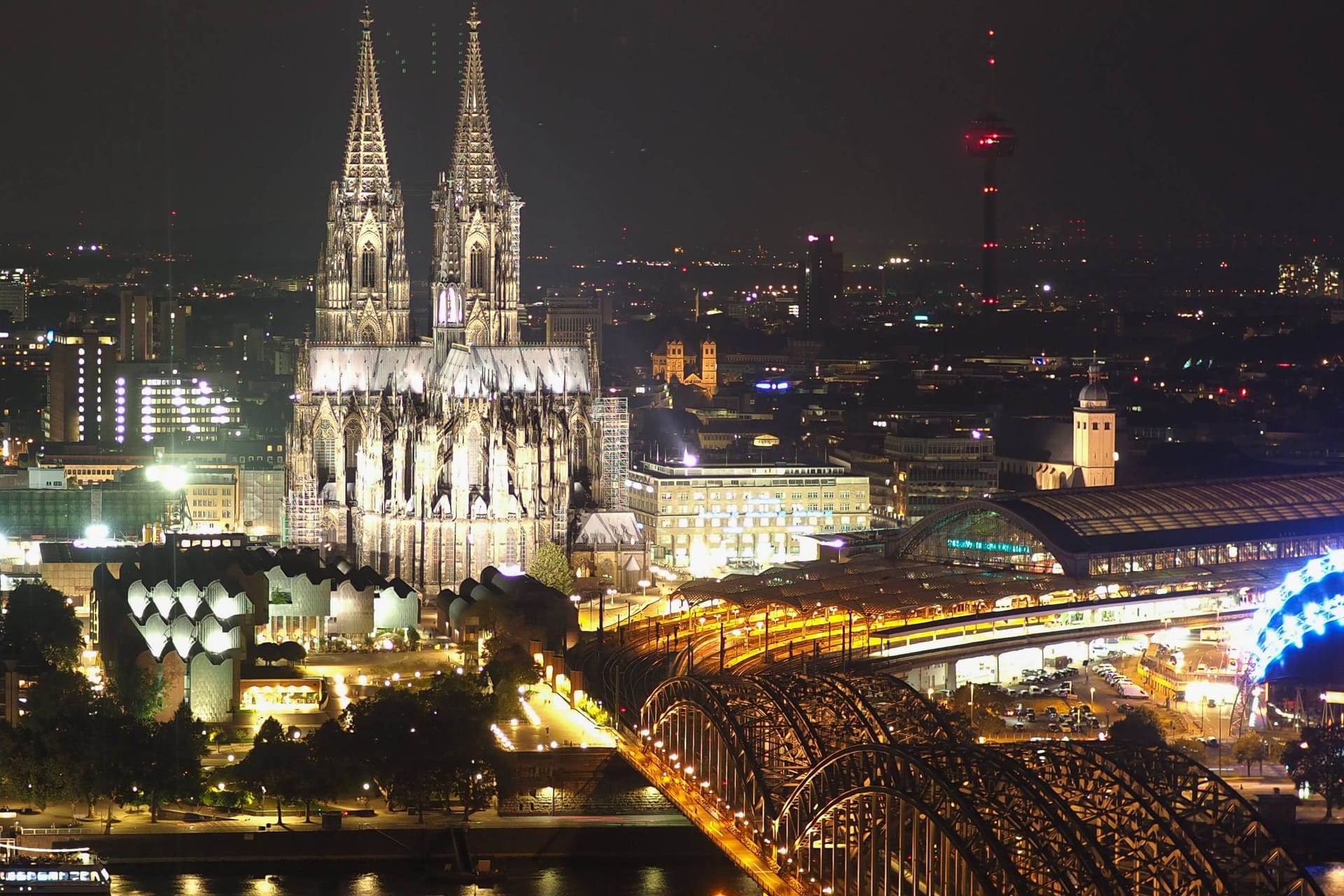 Kölner Dom und Hohenzollernbrücke im Dunkeln (Archivbild): Das Nachtleben fördert die Zufriedenheit der Menschen.