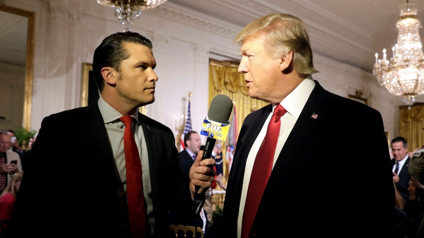 FILE PHOTO: U.S. President Donald Trump is interviewed by Fox and Friends co-host Pete Hegseth at the White House in Washington