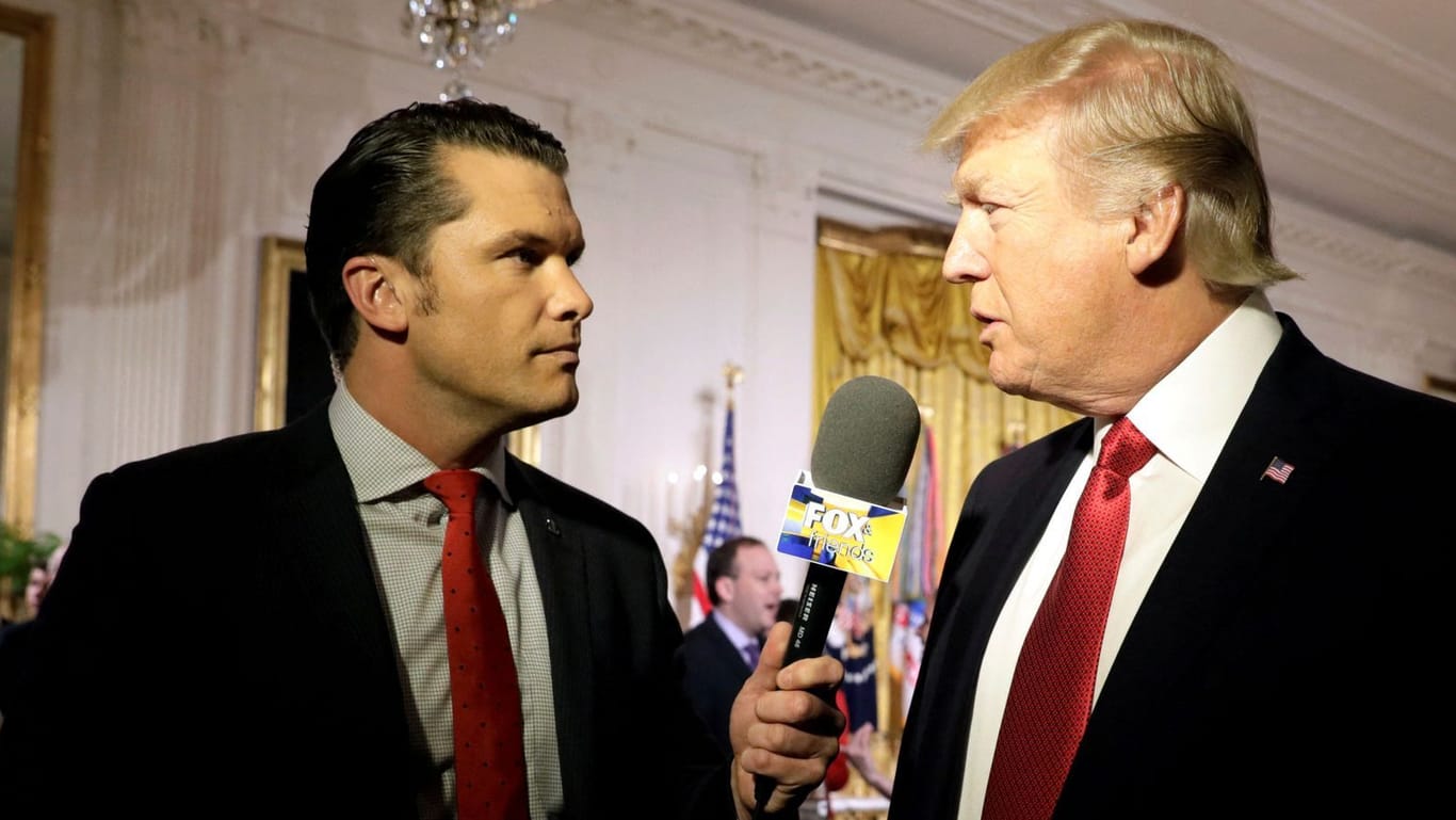 FILE PHOTO: U.S. President Donald Trump is interviewed by Fox and Friends co-host Pete Hegseth at the White House in Washington