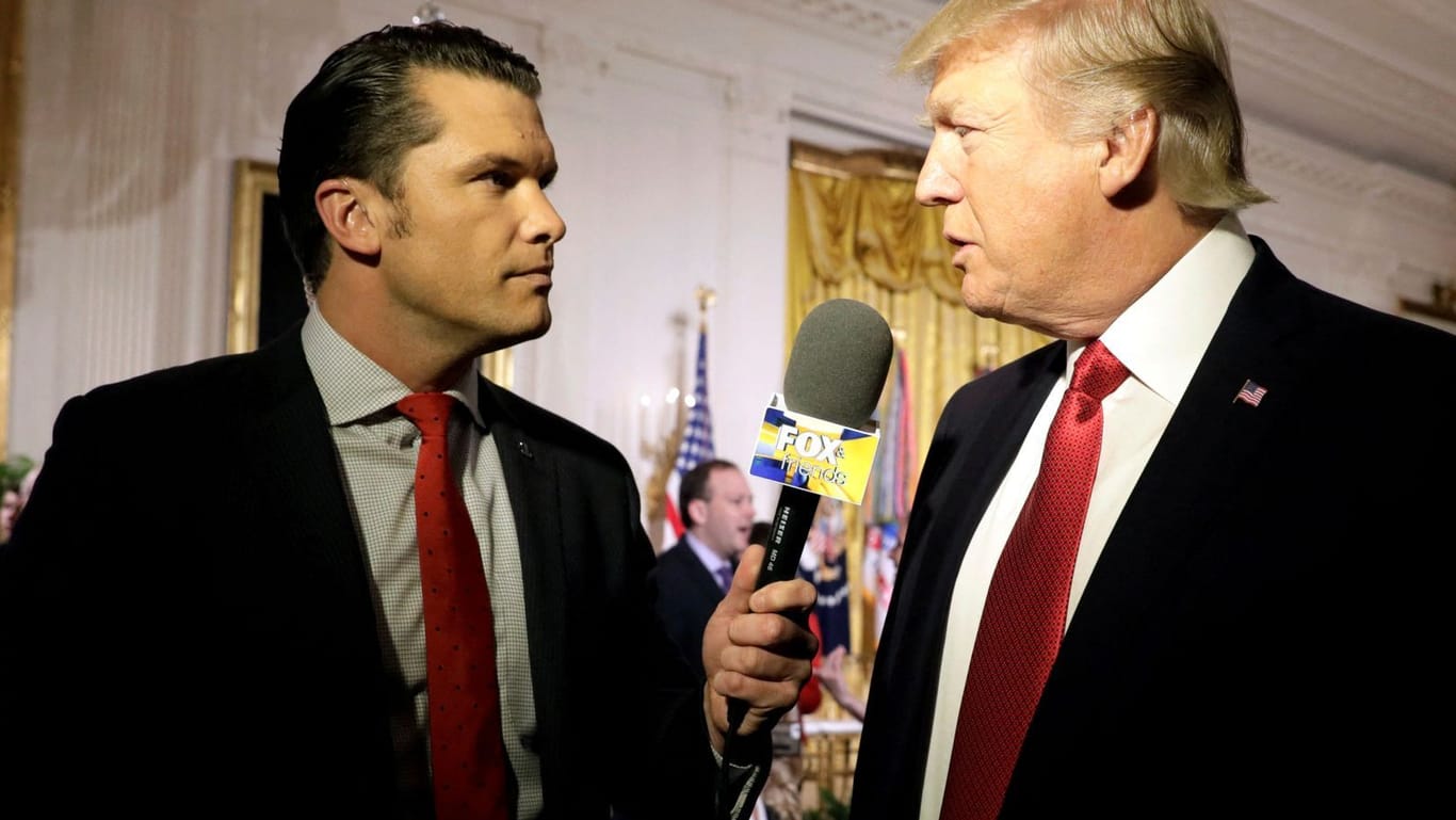 FILE PHOTO: U.S. President Donald Trump is interviewed by Fox and Friends co-host Pete Hegseth at the White House in Washington