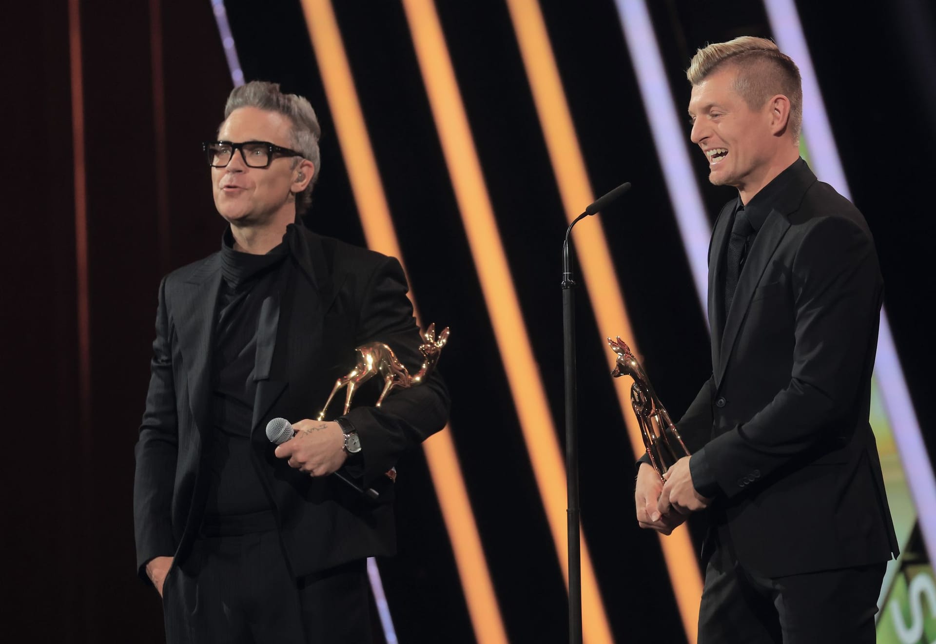 Robbie Williams (l.) und Toni Kroos sind Fans voneinander.