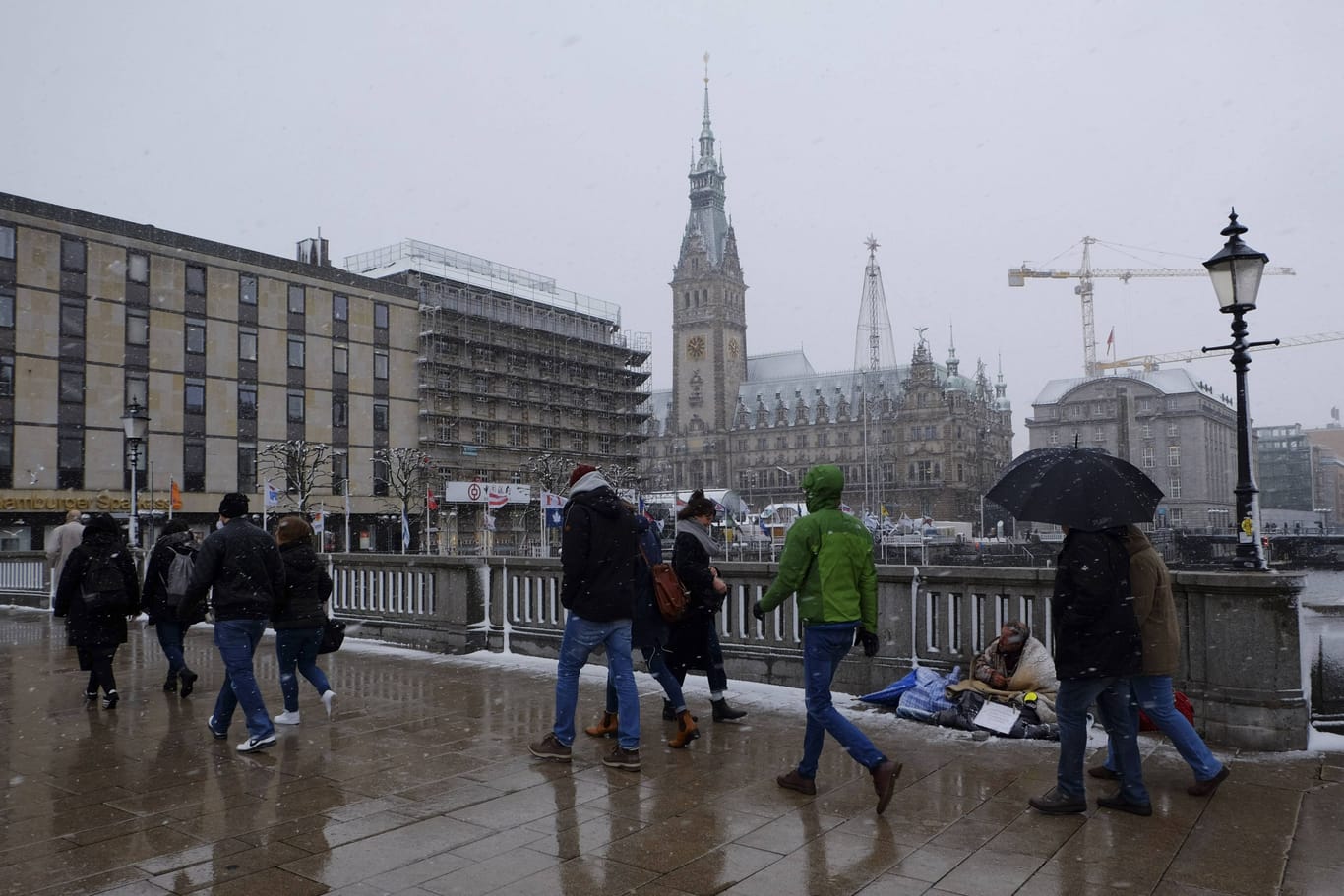 Passanten bei Schnee und Regen am Jungfernstieg (Symbolbild): Am Donnerstag wird es in Hamburg winterlich wechselhaft.