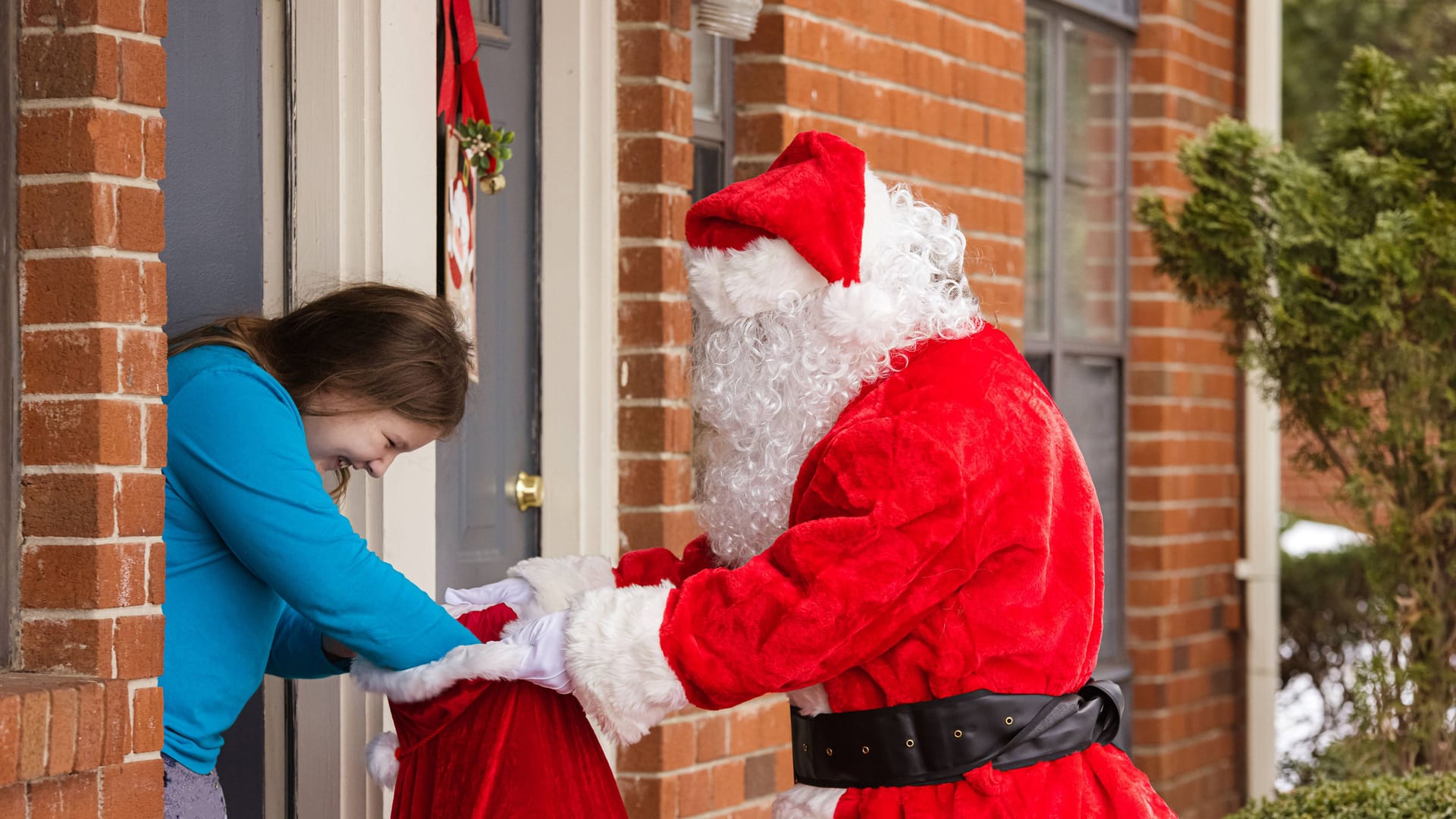 Ein Weihnachtsmann überreicht Geschenke: Die Arbeitsgentur sucht wieder Weihnachtsmänner.