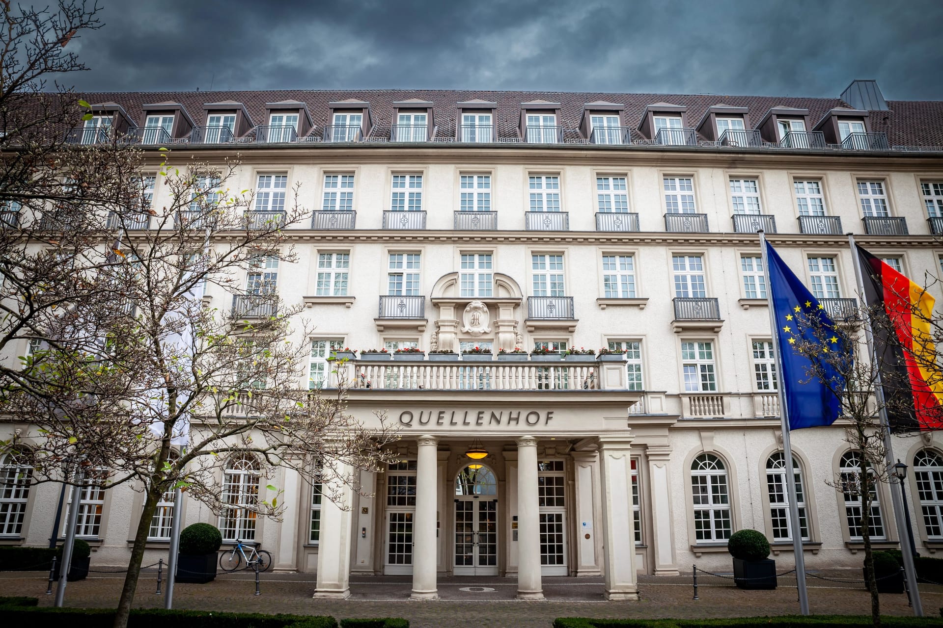 AACHEN, GERMANY - NOVEMBER 7, 2022: Quellenhof hotel entrance with a focus on its signage. Quellenhof is a luxury hotel and restaurant, part of the Bad aachen thermal spa complex and resort