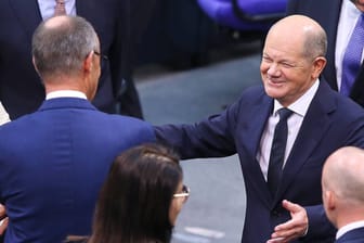 Olaf Scholz (r) will Friedrich Merz umarmen: Die Union stimmte im Bundestag mit den Ex-Ampelparteien SPD und Grüne.