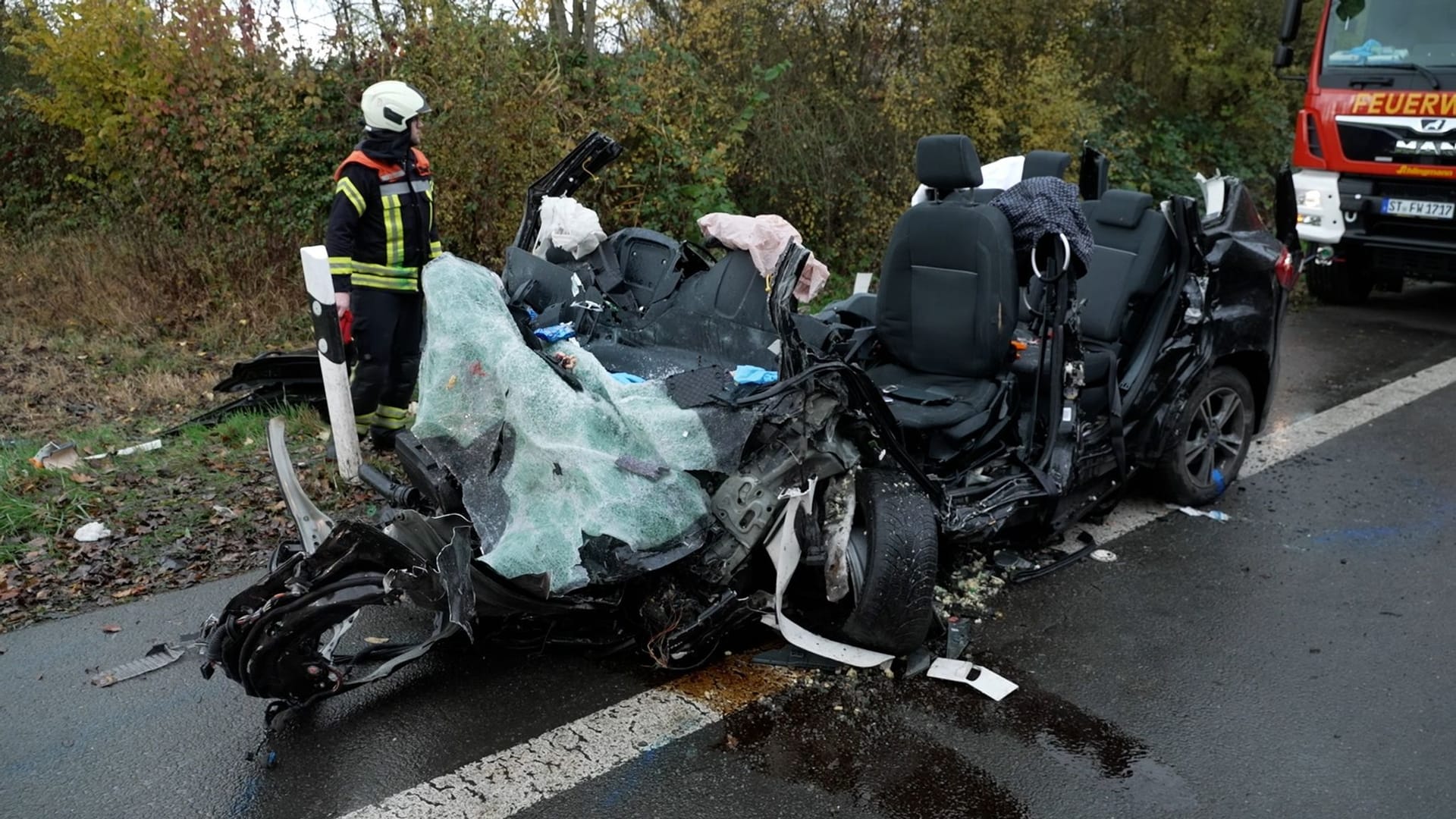 Rettungskräfte neben den Trümmern: Die Autos stießen frontal zusammen.