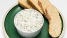 Traditional homemade greek yogurt sauce Tzatziki, tarator in white bowl, grated cucumbers, sour cream yogurt,olive oil,garlic,herbs on plate with sliced bread, white background.Horizontal