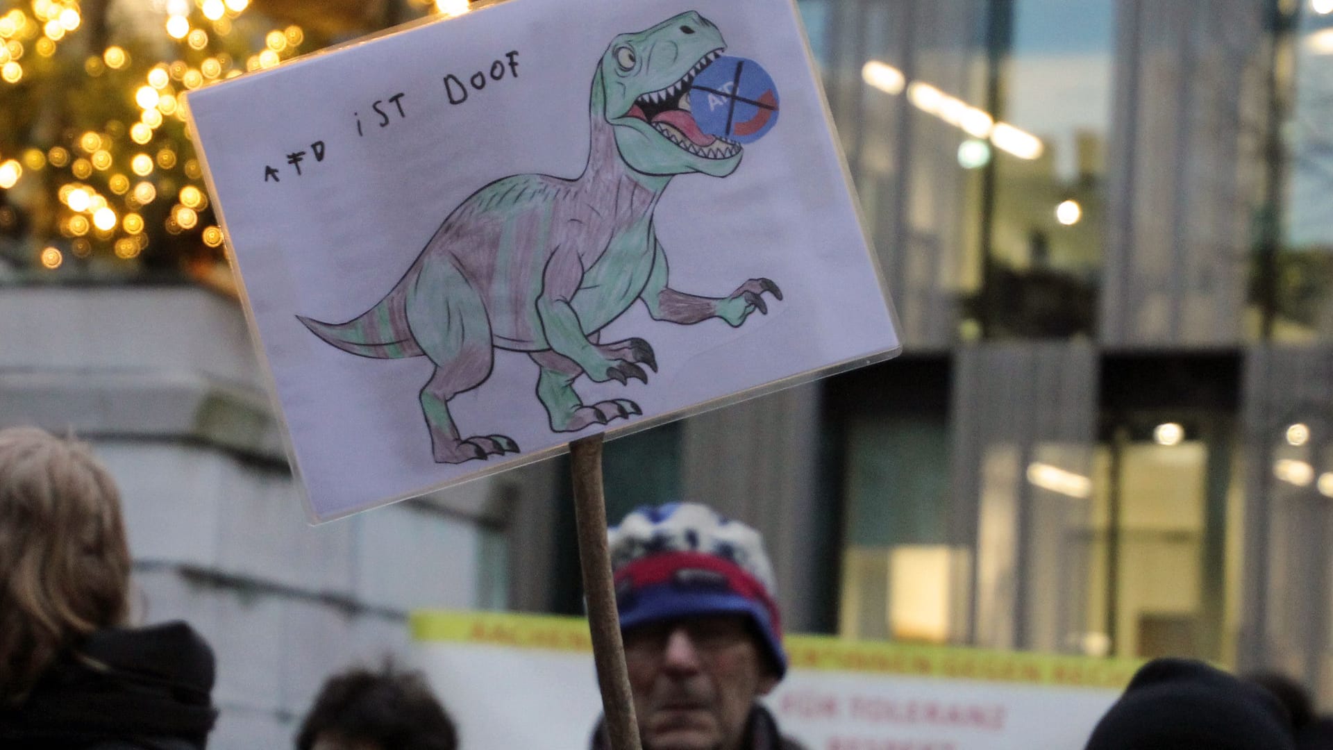 Bildhafter Protest: Ein Dinosaurier frisst das Logo der AfD.