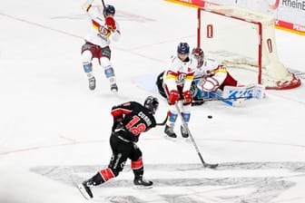 Kölns Josh Currie schießt auf den Kasten von Düsseldorfs Torhüter Henrik Haukeland beim rheinischen Derby am Abend in der Lanxess-Arena.