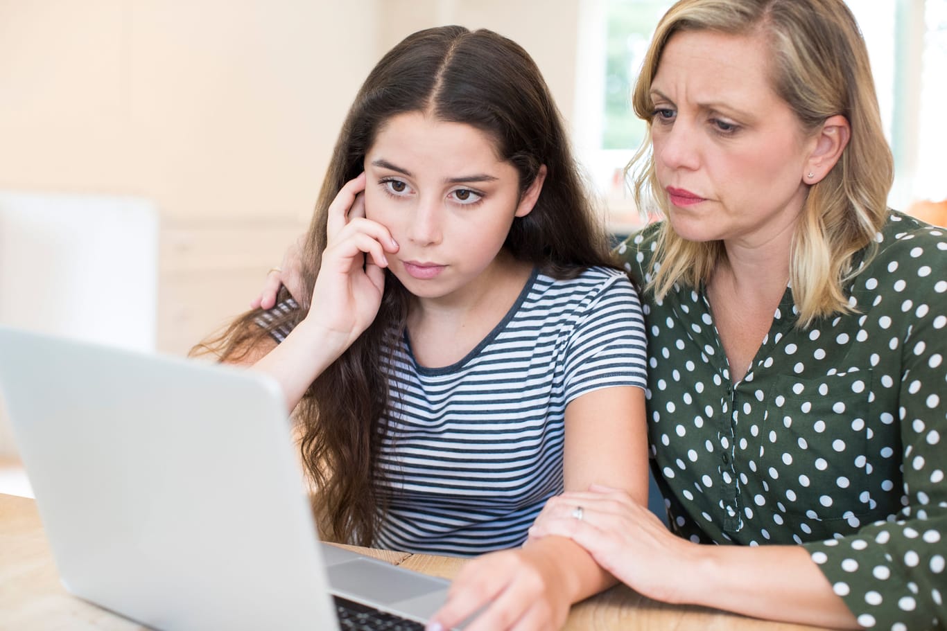 Mother Comforting Daughter Victimized By Online Bullying