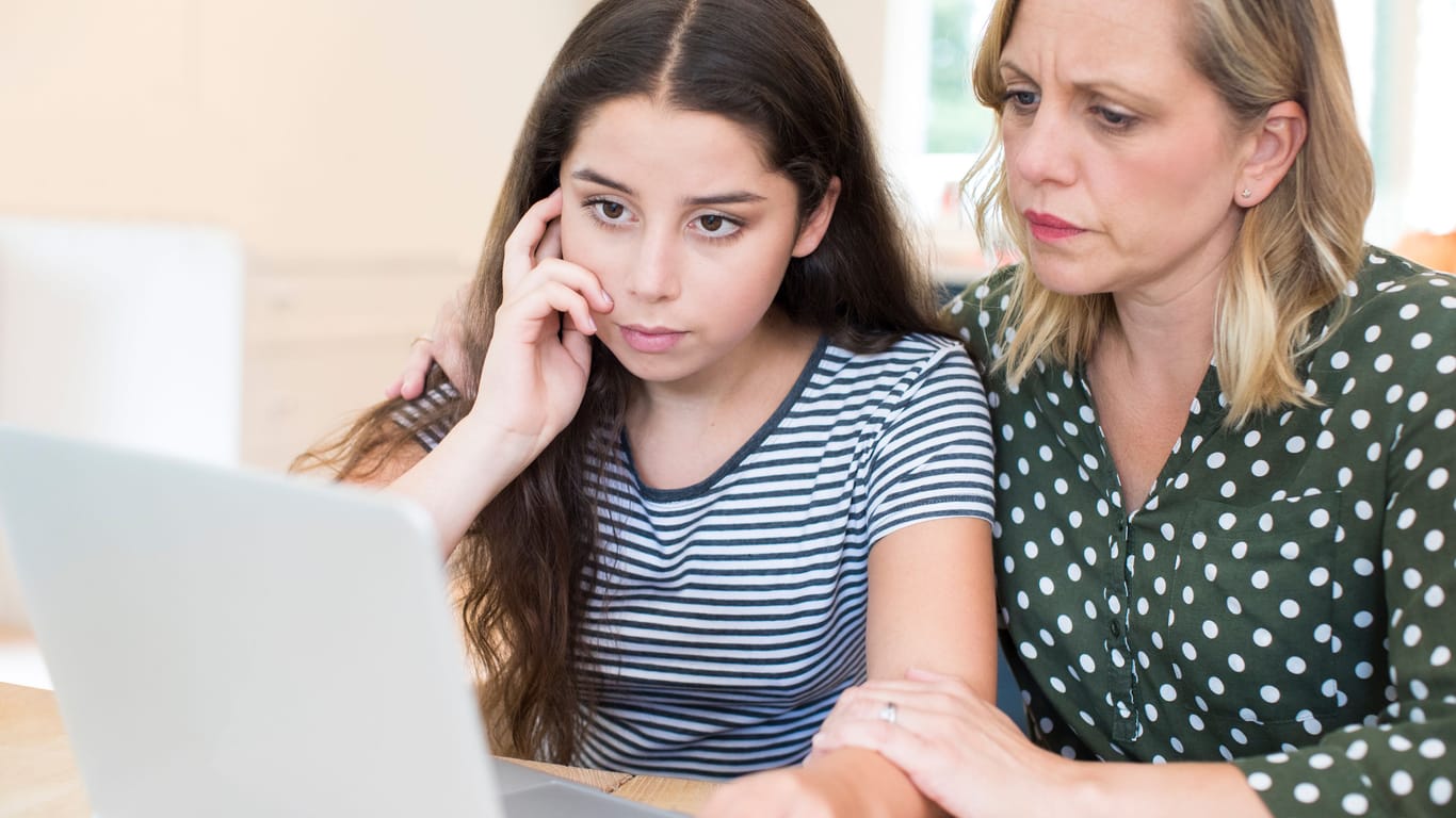 Mother Comforting Daughter Victimized By Online Bullying