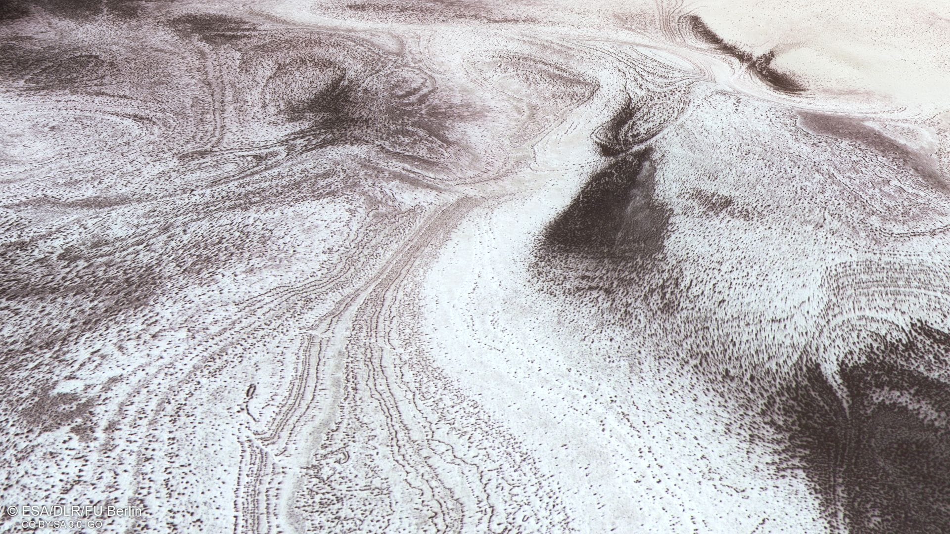 Die Polarlandschaft auf dem Mars zeigt einen Wechsel von Schichten aus hellem Kohlendioxid- und Wassereis mit dunklen Sanden und Stäuben.