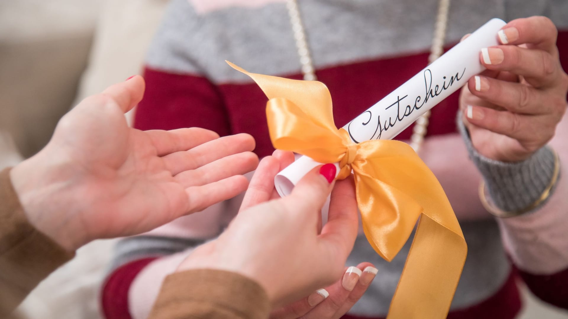 A woman presents a gift voucher