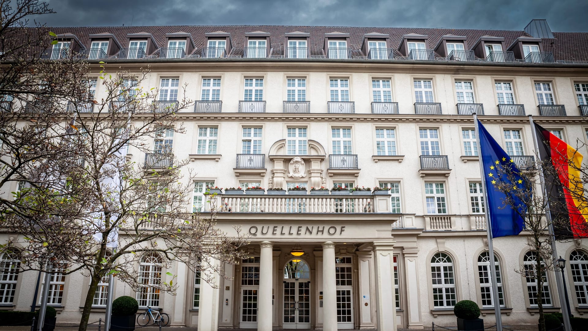 AACHEN, GERMANY - NOVEMBER 7, 2022: Quellenhof hotel entrance with a focus on its signage. Quellenhof is a luxury hotel and restaurant, part of the Bad aachen thermal spa complex and resort