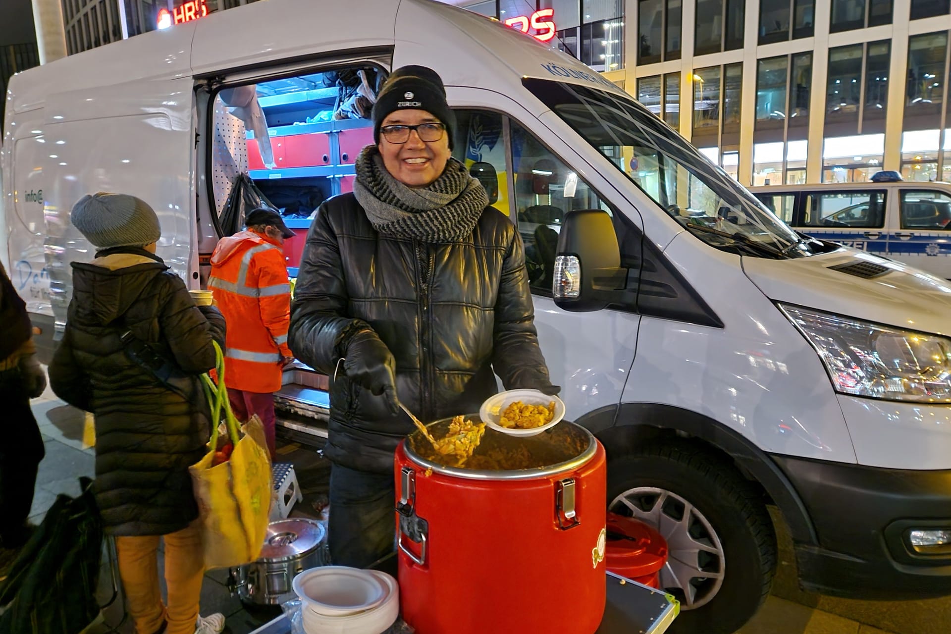 Ein Mitarbeiter des Kältebus verteilt warmes Essen an Bedürftige. Zweimal die Woche steht der Bus am Breslauer Platz.