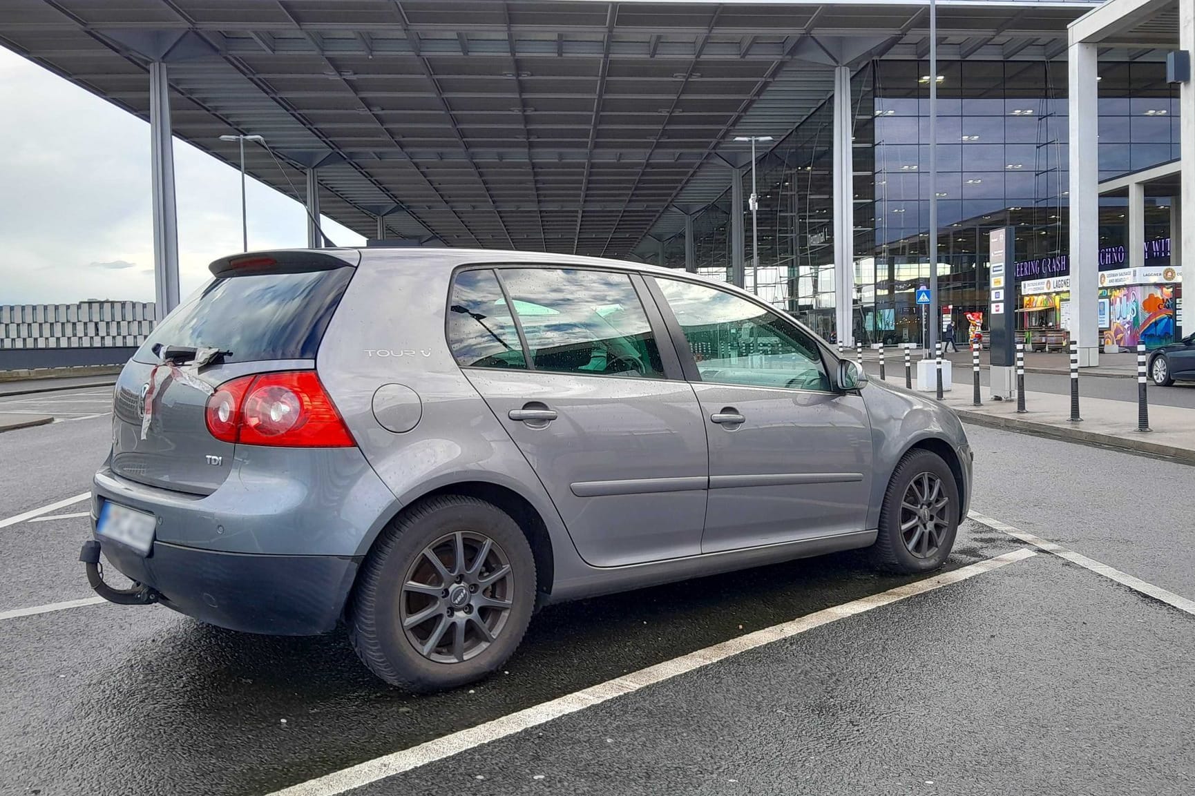 27.01.2025, Brandenburg, Schönefeld: Ein Fahrzeug steht auf dem Kurzzeitparkplatz des Flughafen n Berlin Brandenburg BER. In Berlin macht das Auto Schlagzeilen, für das mittlerweile rund 200.000 Euro Parkgebühren aufgelaufen sein sollen. Seit über einem Jahr stehe der Golf auf dem Kurzzeitparkplatz des Flughafen BER, bei einer Tagesgebühr von über 550 Euro sei für den Halter inzwischen ganz schön was zusammengekommen, berichtet die «Berliner Zeitung». Foto: Anja Sokolow/dpa-Zentralbild/dpa - ACHTUNG: Das Kennzeichen wurde aus rechtlichen Gründen gepixelt