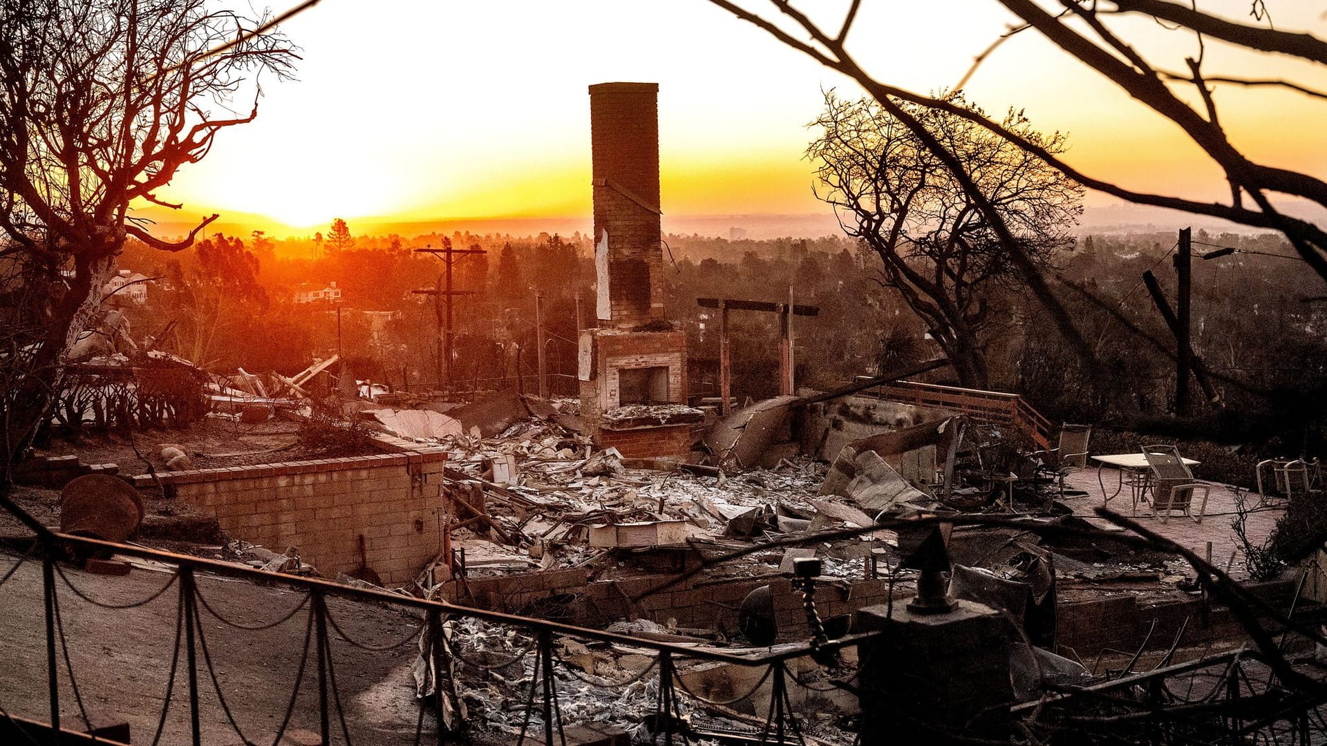 Los Angeles: Die Sonne geht hinter einem durch das Feuer zerstörten Haus in der Gemeinde Pacific Palisades auf.