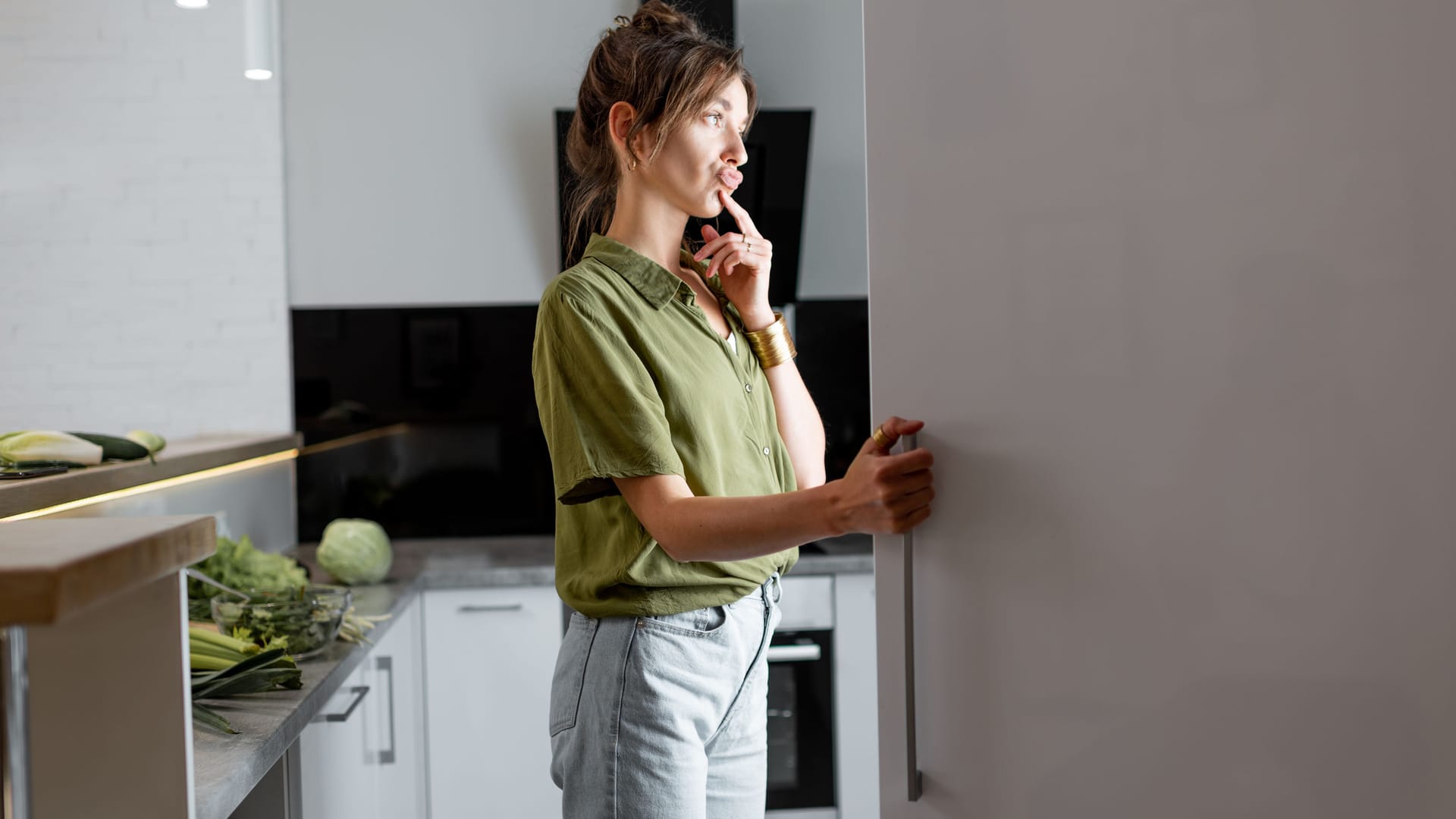 Frau blickt in den Kühlschrank