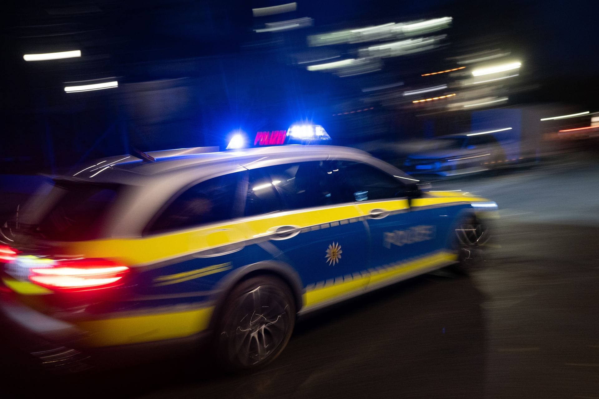 Ein Polizeiauto fährt mit Blaulicht zum Einsatz. (Symbolbild)