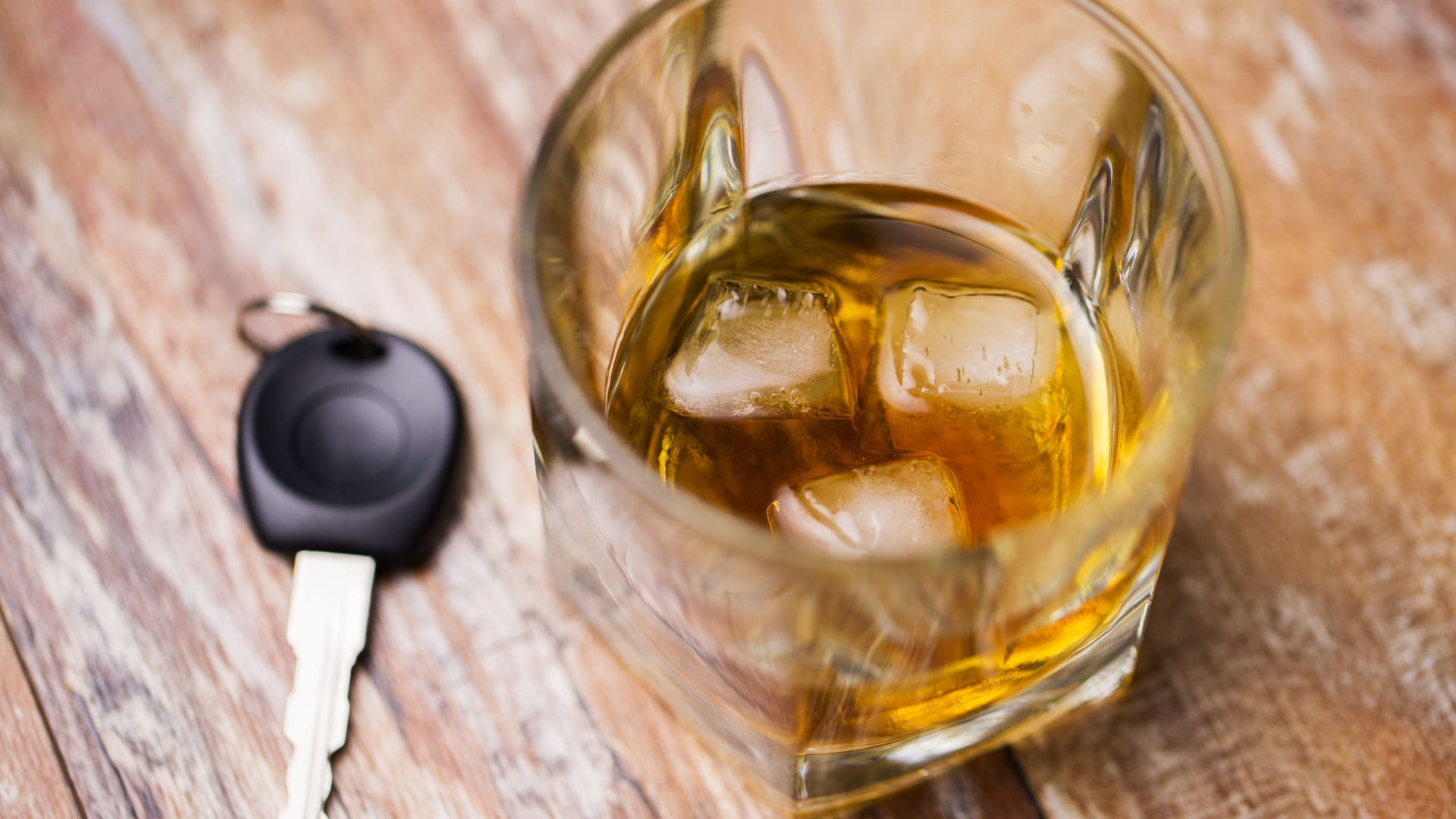 close up of alcohol and car key on table