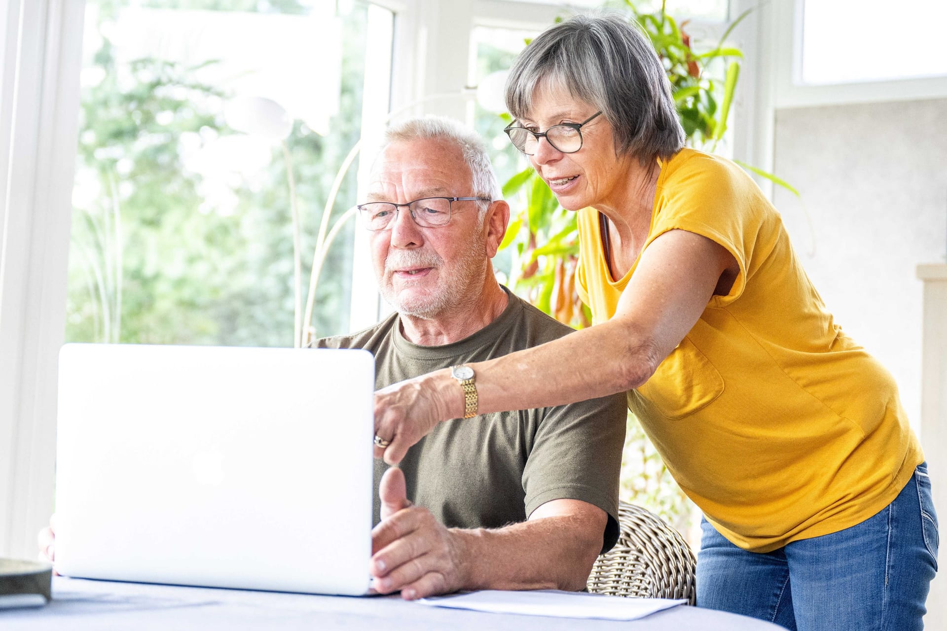 Paar am Laptop: Die Zinsentwicklung könnte Sparer zu einem Denkfehler verleiten.