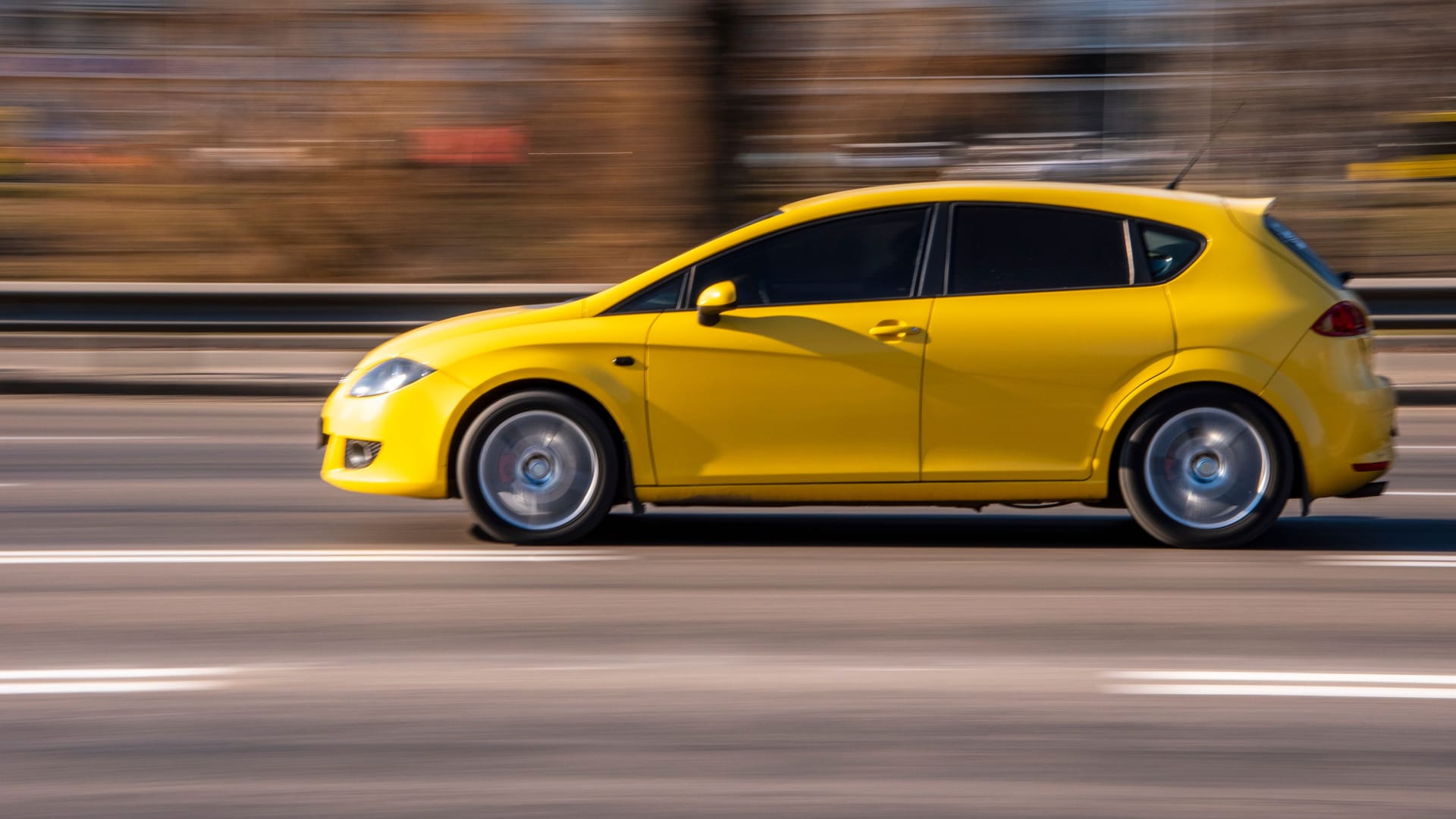 Ukraine, Kyiv - 11 March 2021: Yellow Seat Leon car moving on the street;