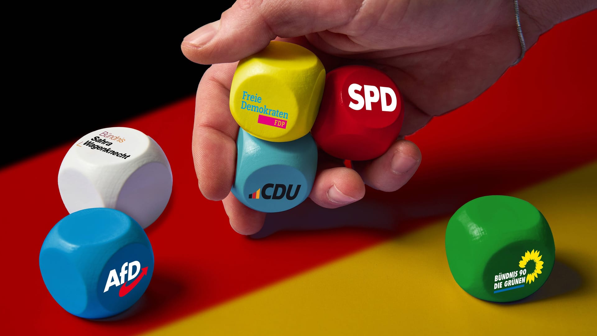 imago images 0787196152Bavaria, Germany - December 20, 2024: Symbolic image for the 2025 federal election: cube with the logos of the CDU, SPD, Bündnis 90/Die Grünen, FDP, AfD and Bündnis Sahra Wagenknecht parties in front of the German flag. The image stands for political diversity, the choice of citizens and the future of government formation in Germany. PHOTOMONTAGE