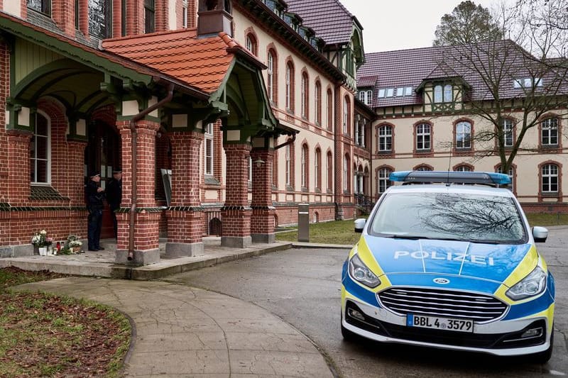 Ein Polizeifahrzeug steht vor einem Haus: In dem Gebäude hat es mehrere Gewaltverbrechen gegeben.