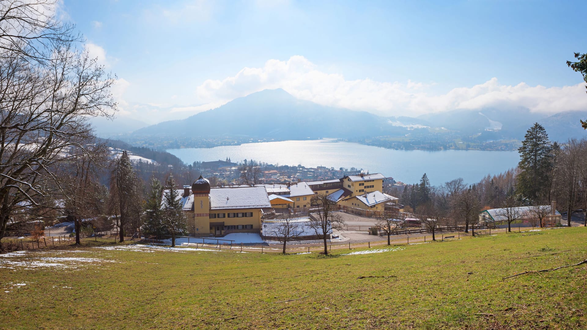 view from hiking trail to lake tegernsee and mountain hotel