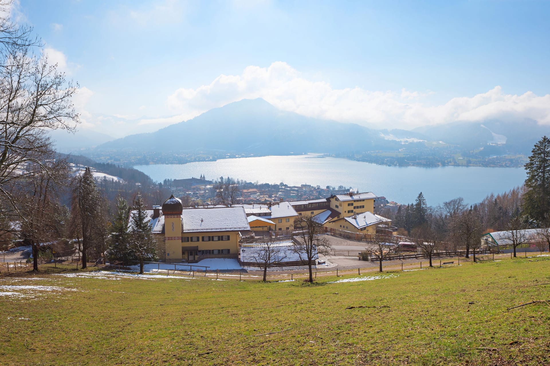 view from hiking trail to lake tegernsee and mountain hotel