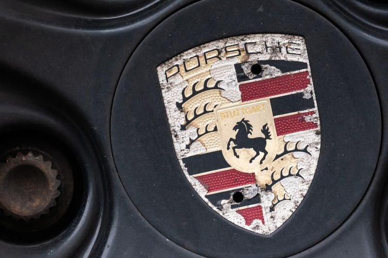 Ein Logo der Porsche AG ist an einer Felge (Symbolbild): Der Autohersteller baut fast 2.000 Stellen in Deutschland ab.