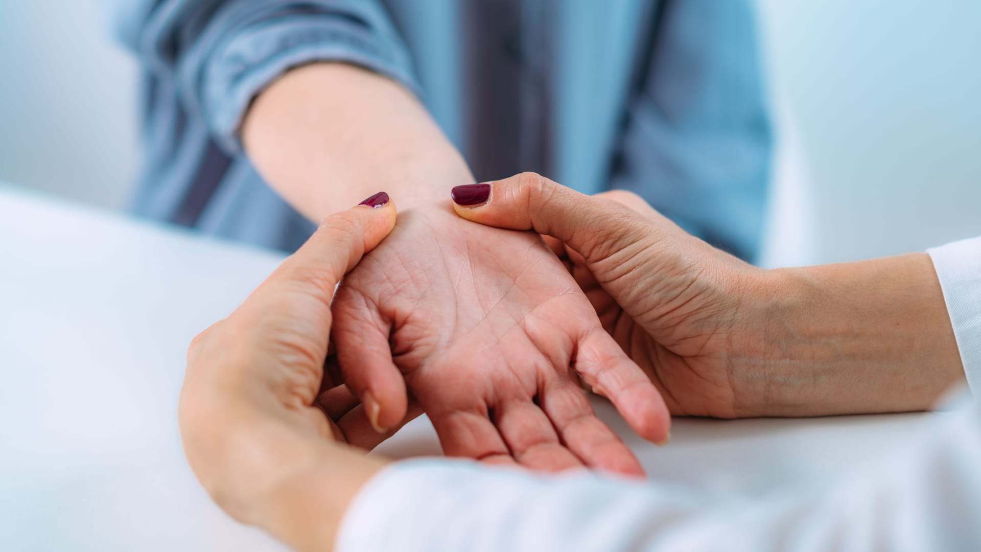 Eine Ärztin untersucht die Hand einer Patientin: Bei einem Karpaltunnelsyndrom lassen die Beschwerden mit einer Schiene in vielen Fällen nach.