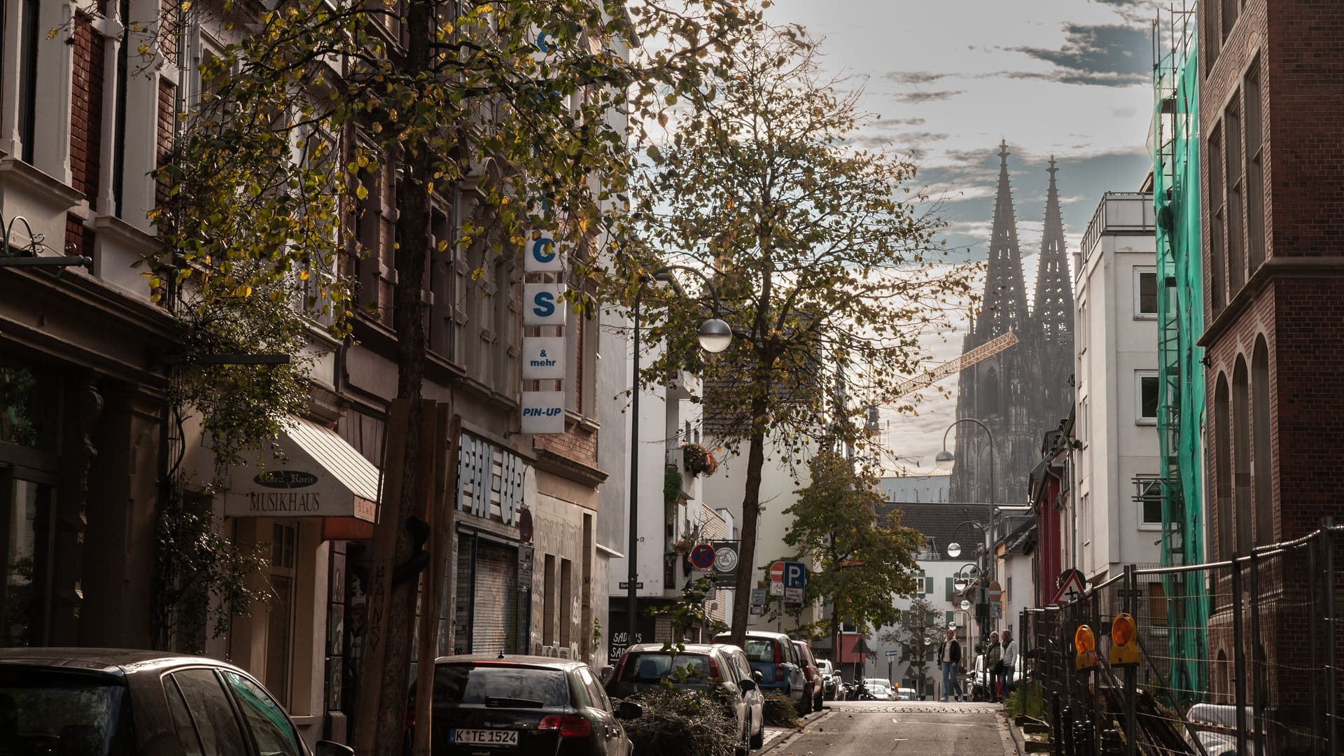 COLOGNE, GERMANY - NOVEMBER 9, 2022: Ritterstrasse street, a typical residential street of the old town of Cologne, in the Eigelstein viertel district of Altstadt Koln, with Cathedral in background.