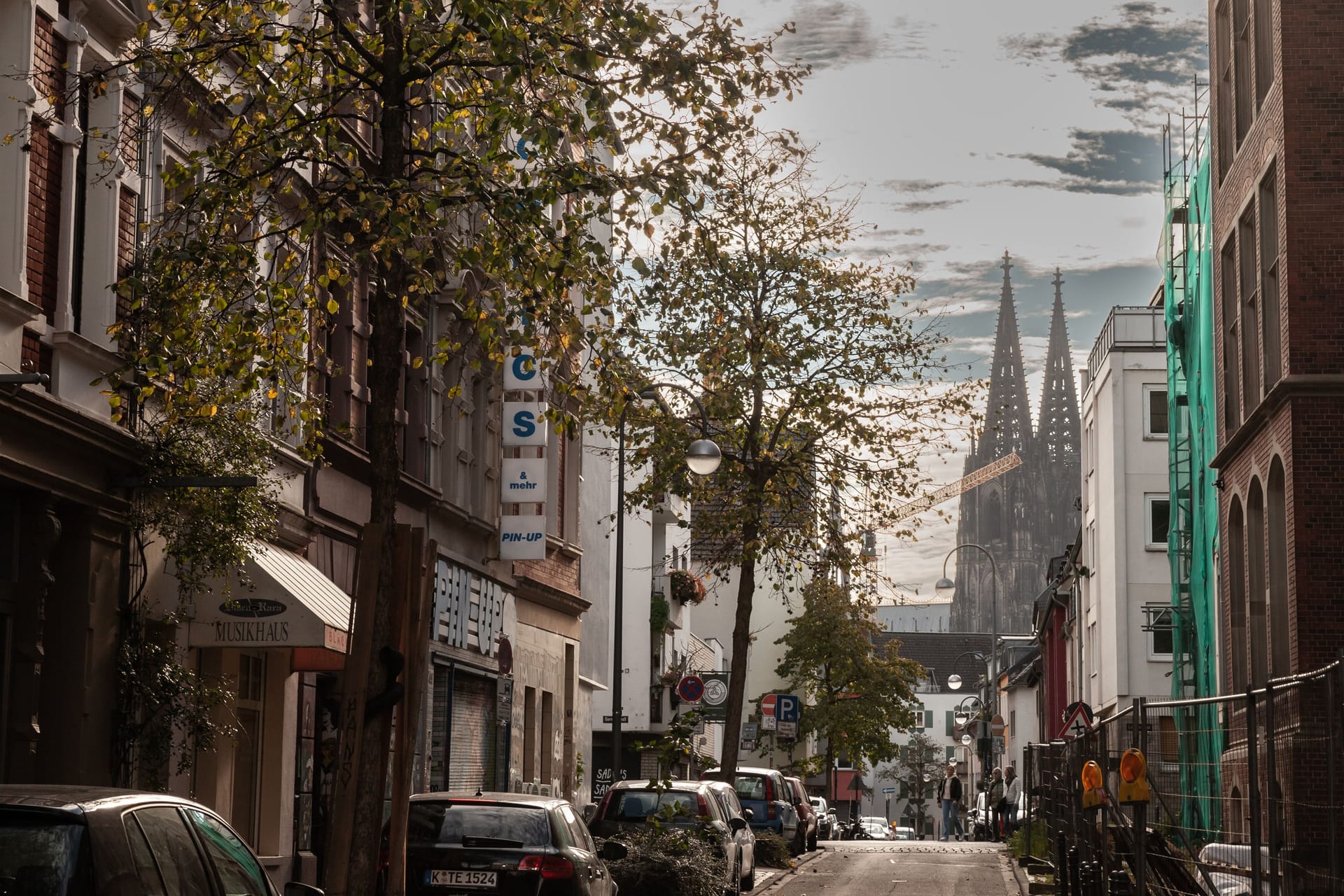 COLOGNE, GERMANY - NOVEMBER 9, 2022: Ritterstrasse street, a typical residential street of the old town of Cologne, in the Eigelstein viertel district of Altstadt Koln, with Cathedral in background.