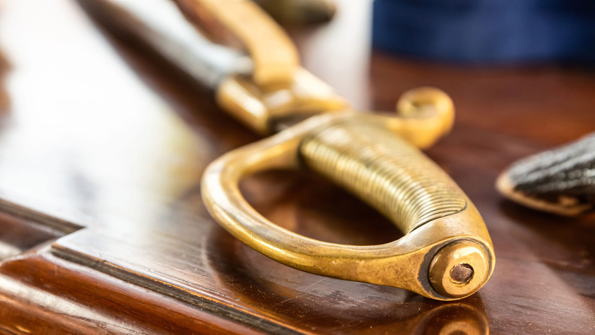 ribbed saber handle close-up lies on a wooden table