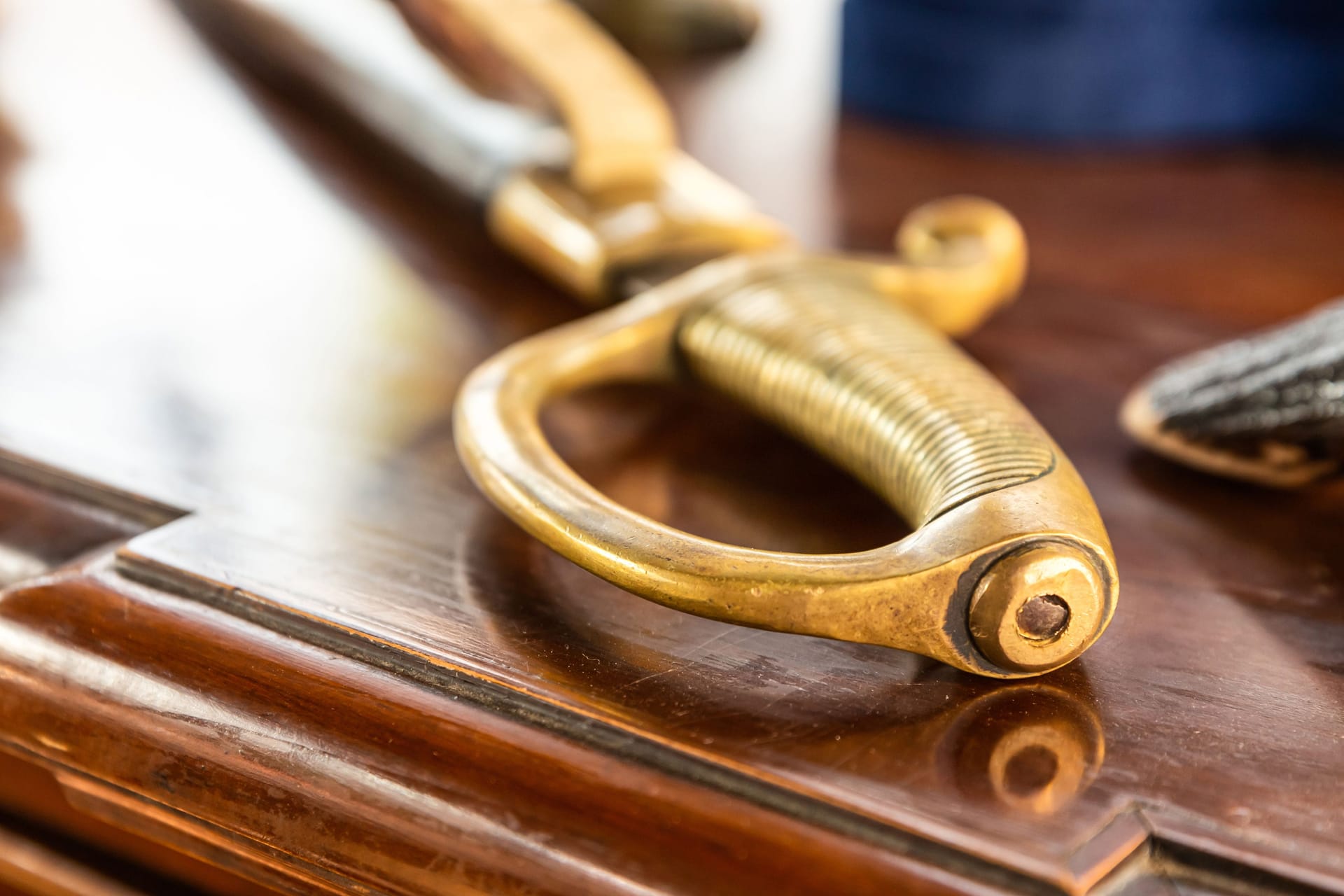 ribbed saber handle close-up lies on a wooden table