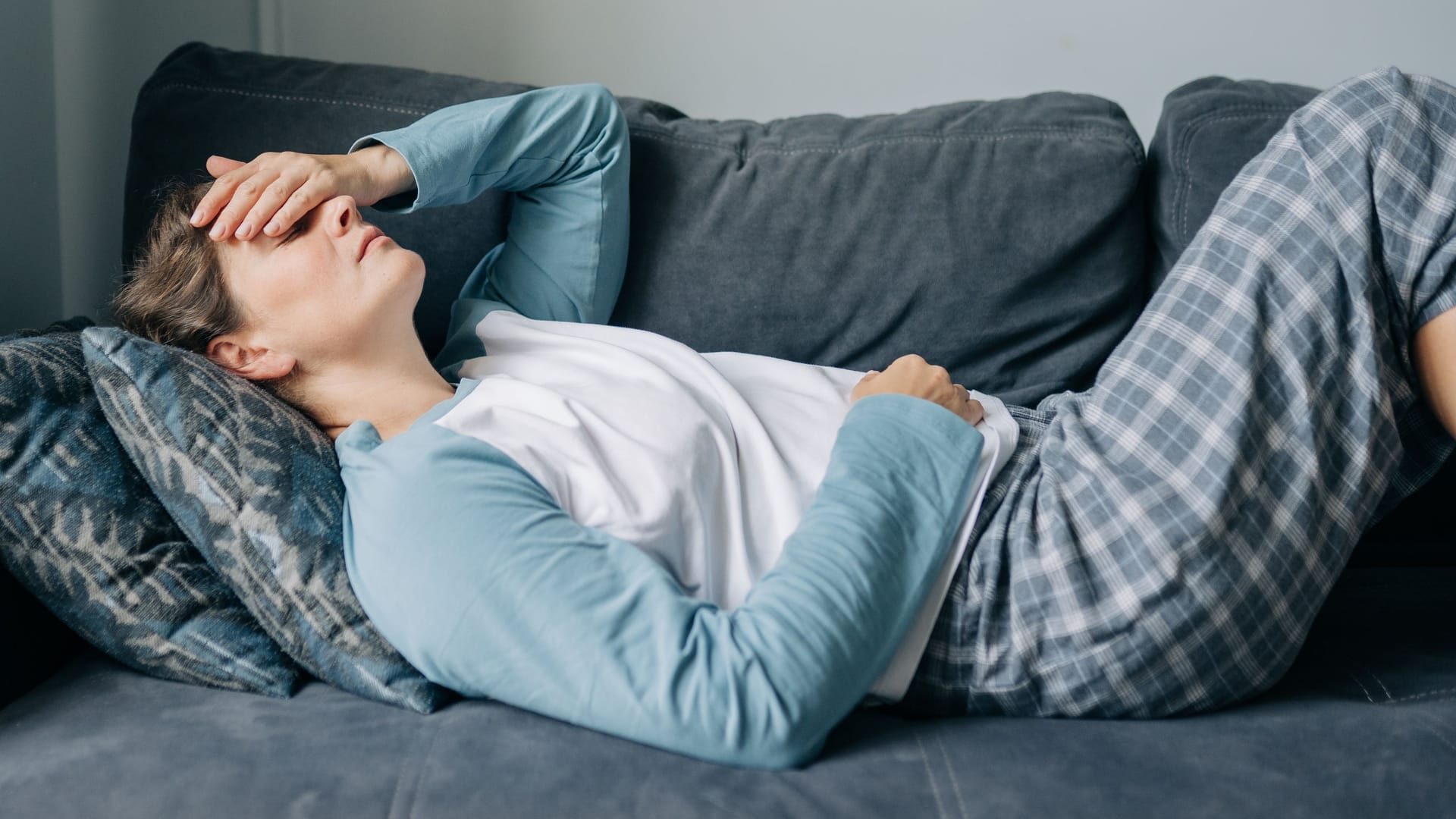 Eine Frau liegt auf einem Sofa