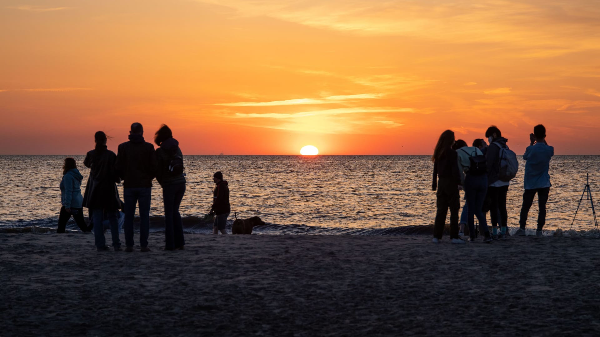 View of people watching a sunset in Noordwijk View of people watching a sunset in Noordwijk