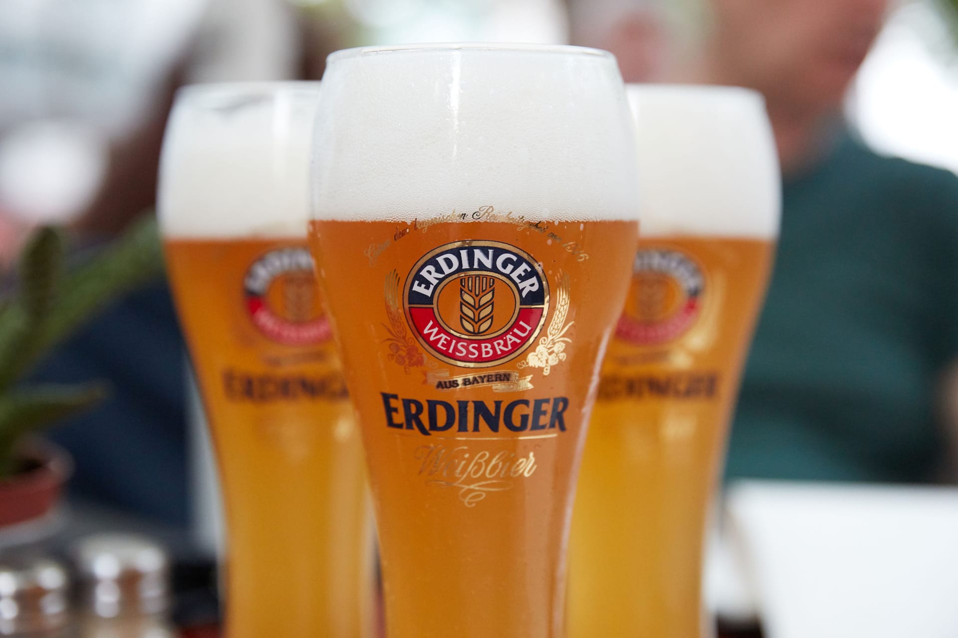 Dusseldorf, Germany 06,06,2016 : Glowing weiss glass of light Erdinger Beer on a pub. bokeh background