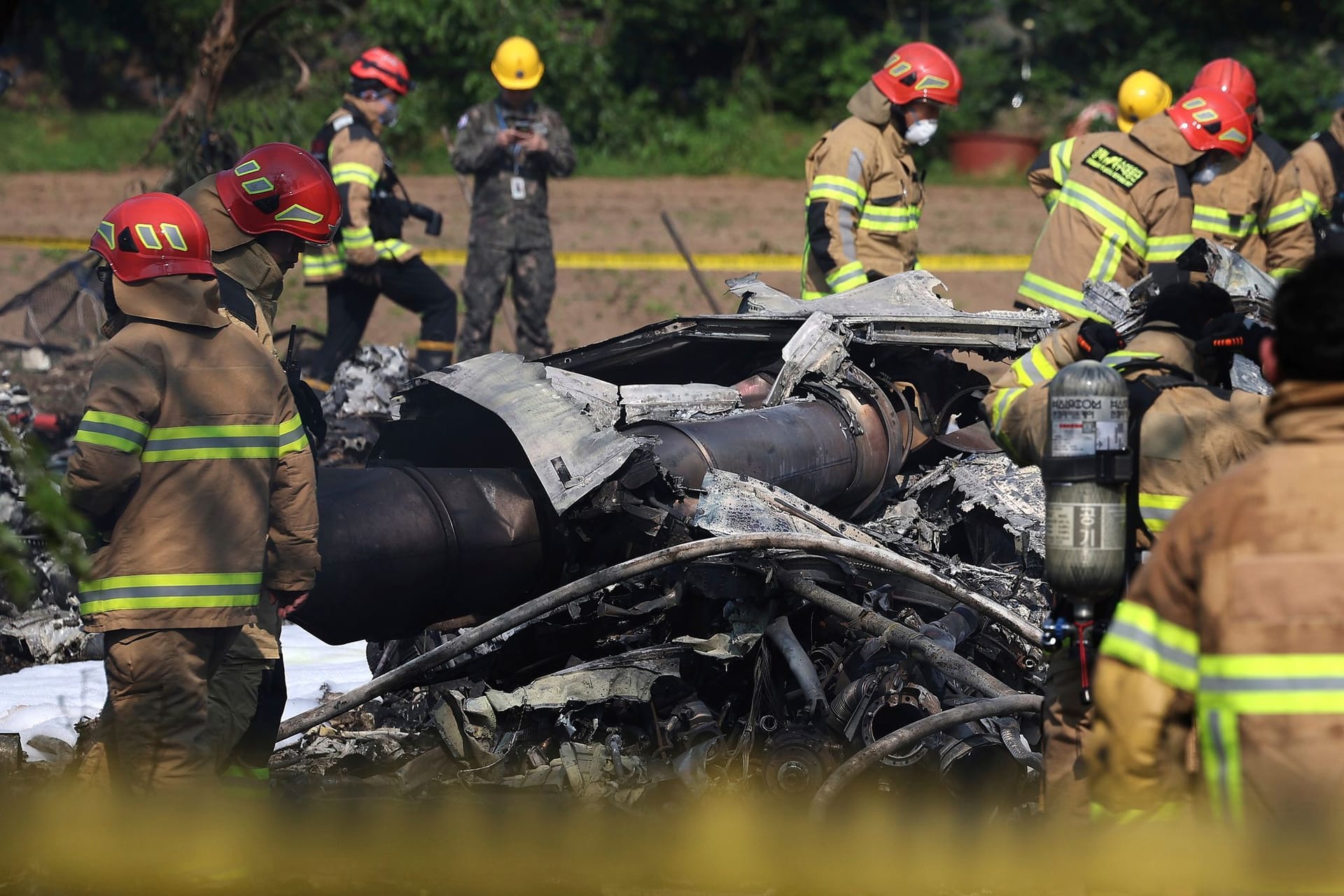 Südkoreanische Feuerwehrleute und Militärs arbeiten am Absturzort eines südkoreanischen Marineflugzeugs.