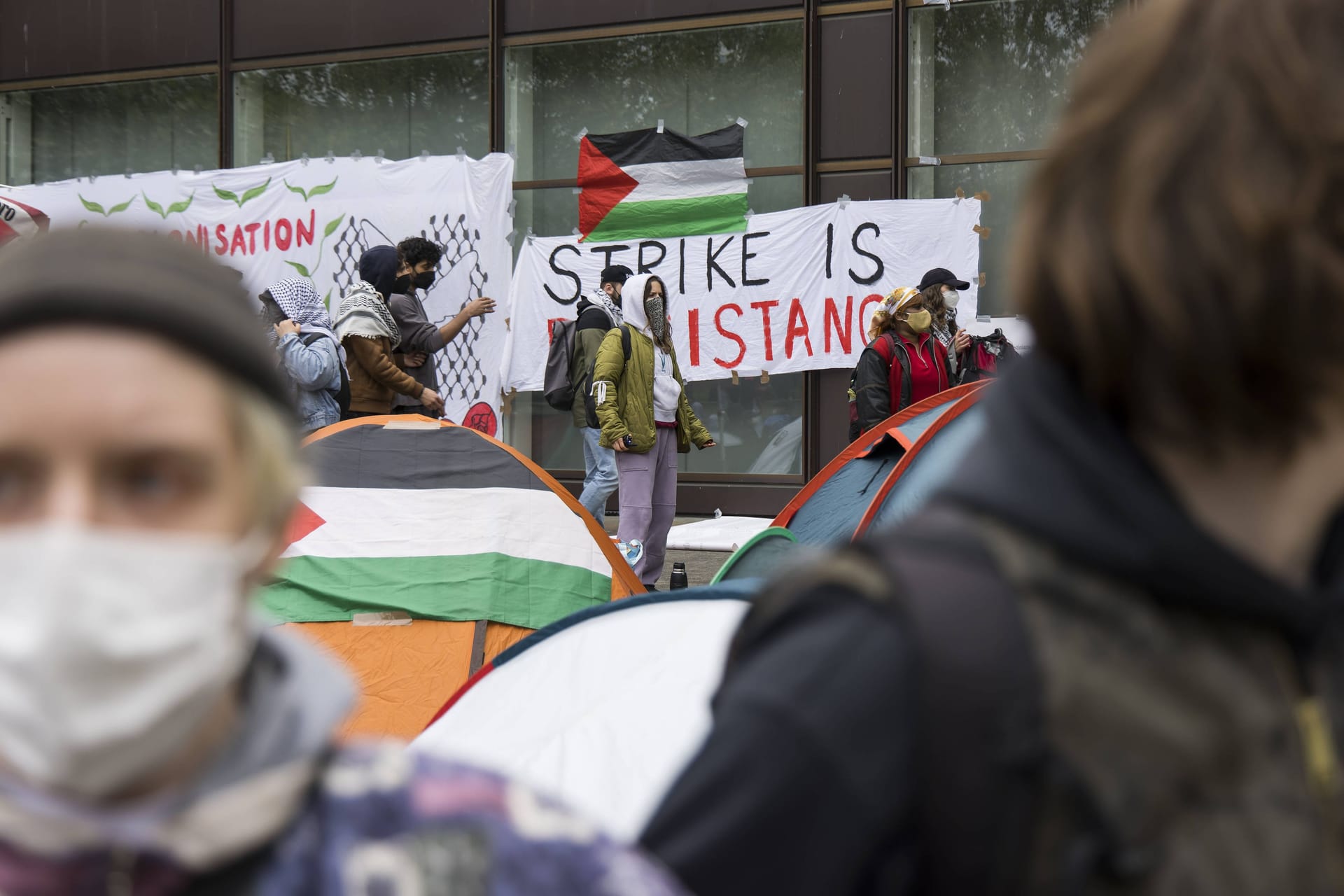 Activists and the flag of the state of Palestine during the occupation of the courtyard of Freie Universität Berlin by pro-Palestinian activists. Some of the approximately 150 activists began to set up tents. The occupation is linked to the advance of the Israeli army Israel Defence Forces, IDF in the southern Gaza Strip near the city of Rafah. The management of the FU Berlin has ordered an evacuation. Berlin, 07.05.2024