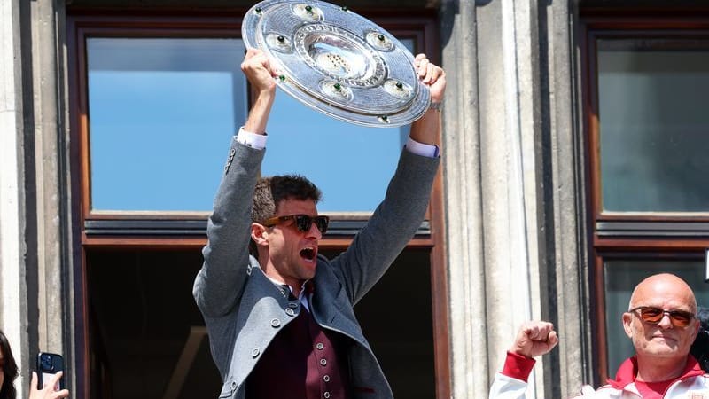 Meisterfeier der Fußballerinnen und Fußballer des FC Bayern München: Thomas Müller (M) jubelt mit der Meisterschale auf dem Rathaus-Balkon. Meisterfeier der Fußballerinnen und Fußballer des FC Bayern München: Thomas Müller (M) jubelt mit der Meisterschale auf dem Rathaus-Balkon.