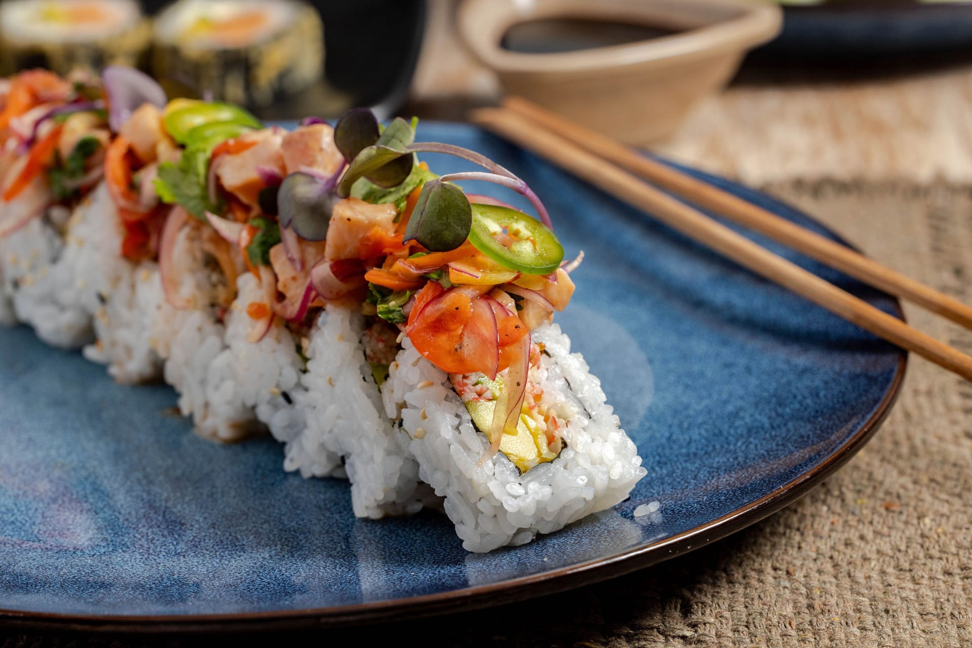 Close-up of sushi rolls with fresh toppings.